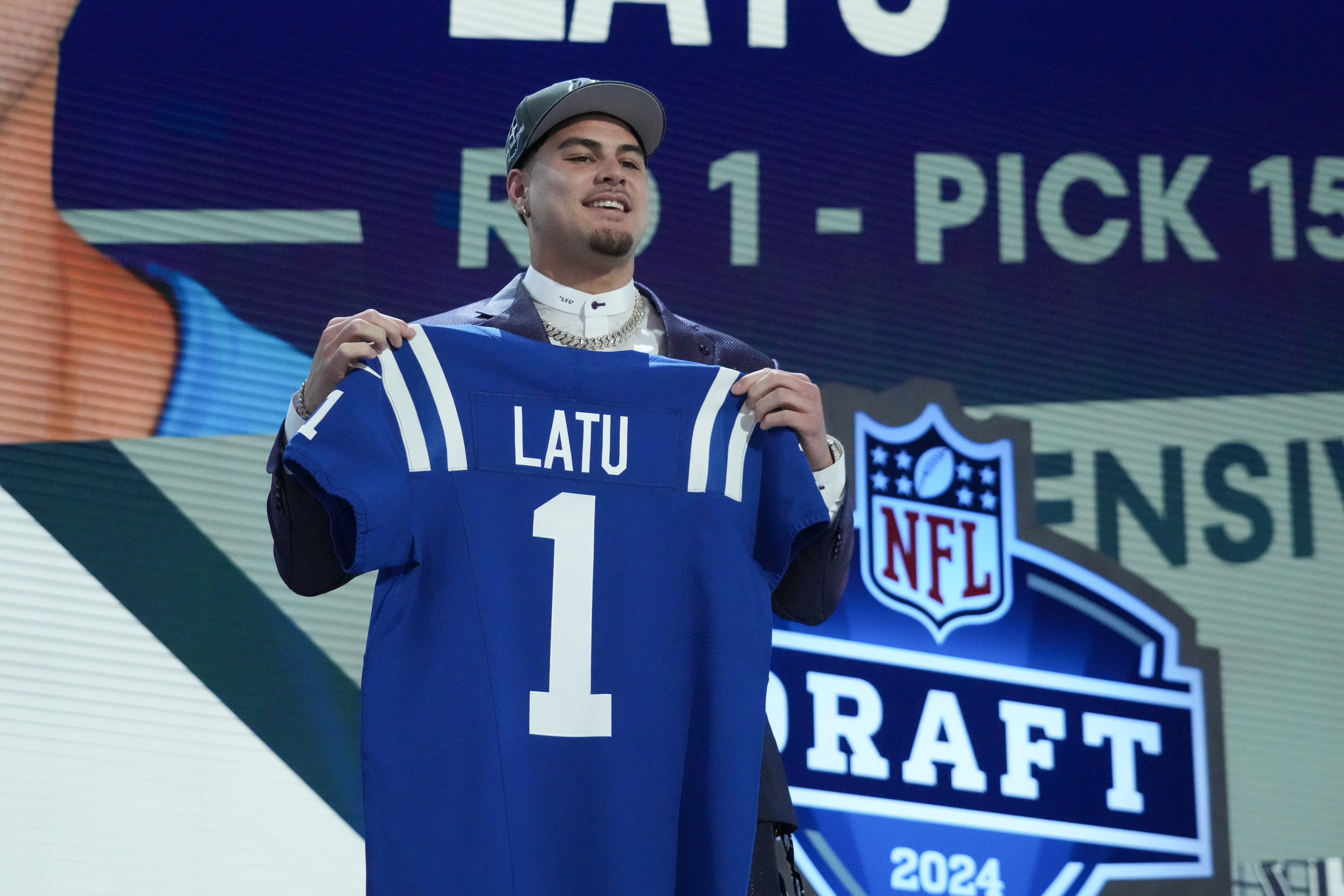 Apr 25, 2024; Detroit, MI, USA; UCLA Bruins defensive lineman Laiatu Latu poses after being selected by the Indianapolis Colts as the No. 15 pick in the first round of the 2024 NFL Draft at Campus Martius Park and Hart Plaza.