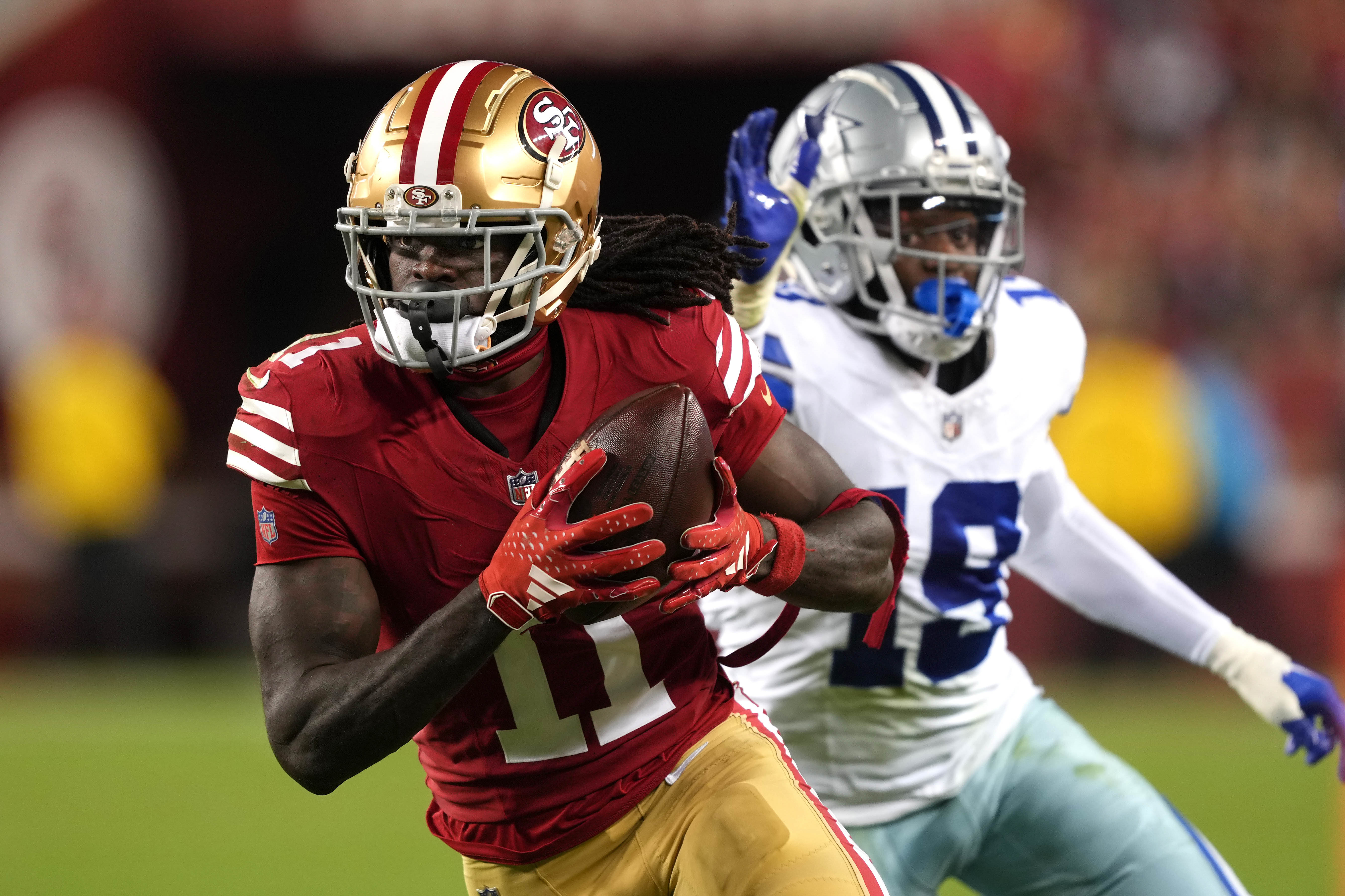 Oct 8, 2023; Santa Clara, California, USA; San Francisco 49ers wide receiver Brandon Aiyuk (11) runs after a catch against Dallas Cowboys cornerback Noah Igbinoghene (19) during the third quarter at Levi's Stadium.