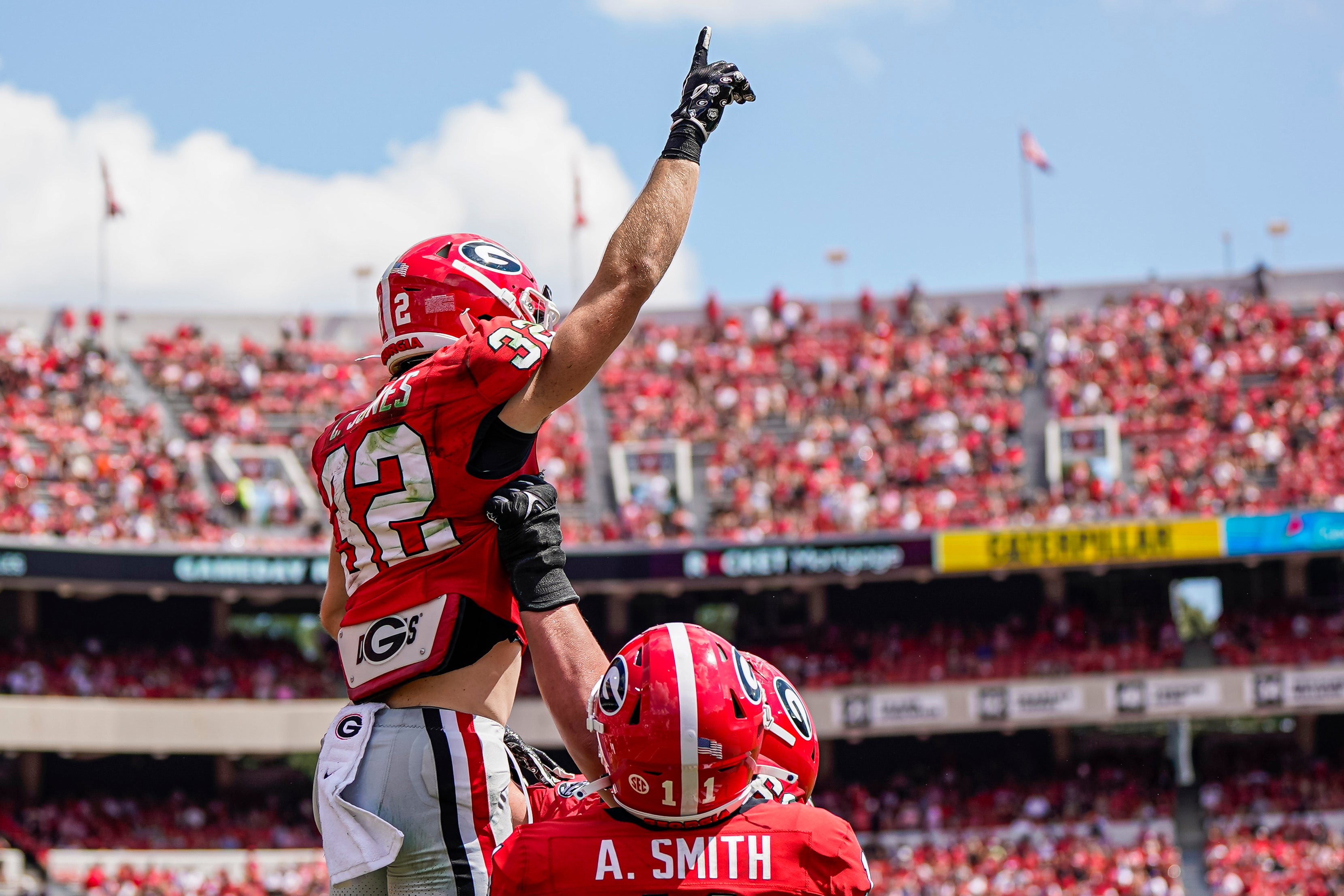 Georgia Bulldogs running back Cash Jones (32) reacts with teammates after catching a touchdown pass against the Ball State Cardinals during the second half at Sanford Stadium.