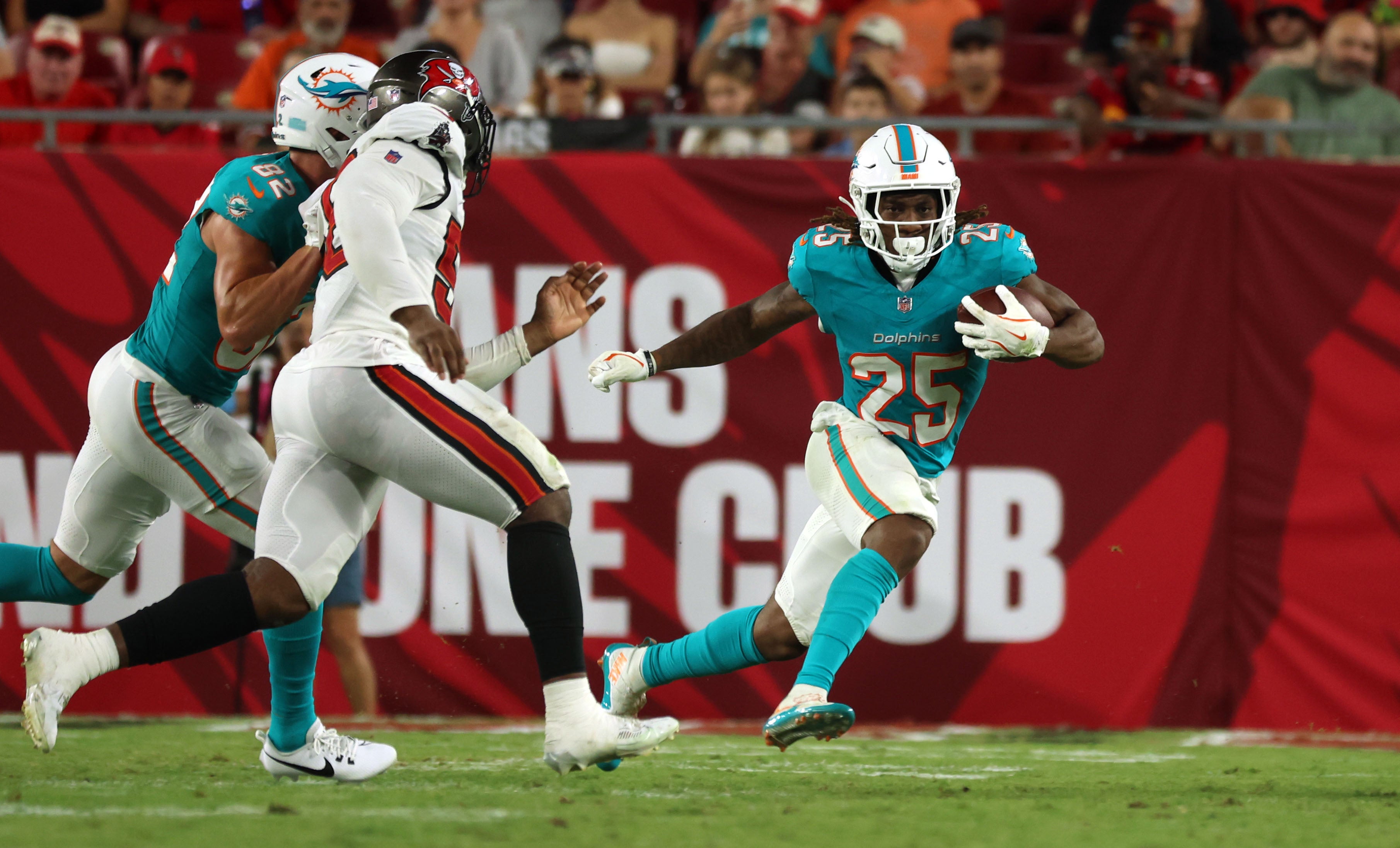 Aug 23, 2024; Tampa, Florida, USA; Miami Dolphins running back Jaylen Wright (25) runs with the ball against the Tampa Bay Buccaneers during the second half at Raymond James Stadium.
