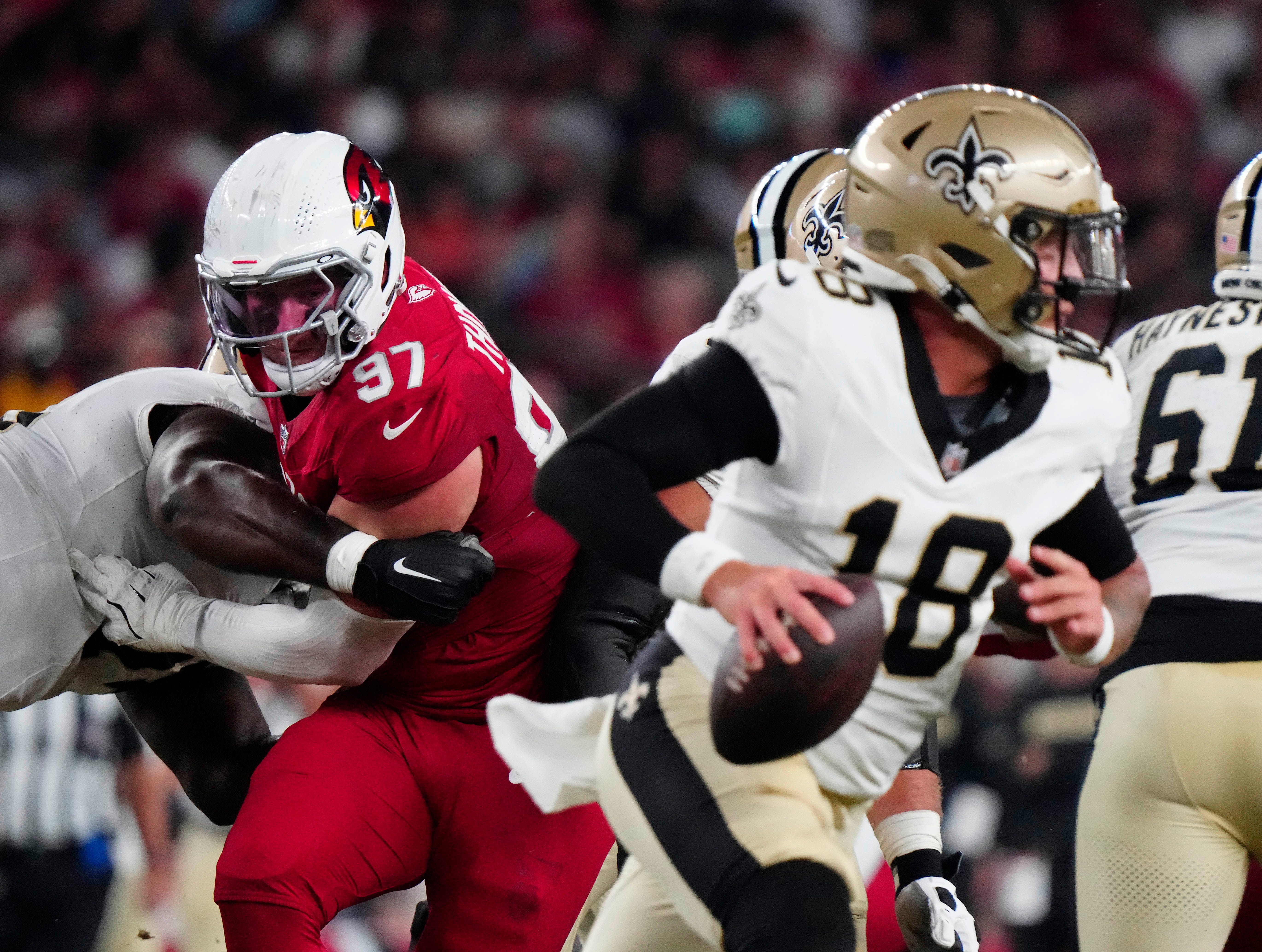 Cardinals defensive lineman Cameron Thomas (97) tries to shed a block and put pressure on Saints quarterback Spencer Rattler (18) during a game at State Farm Stadium in Glendale, Ariz., on Saturday, Aug. 10, 2024.