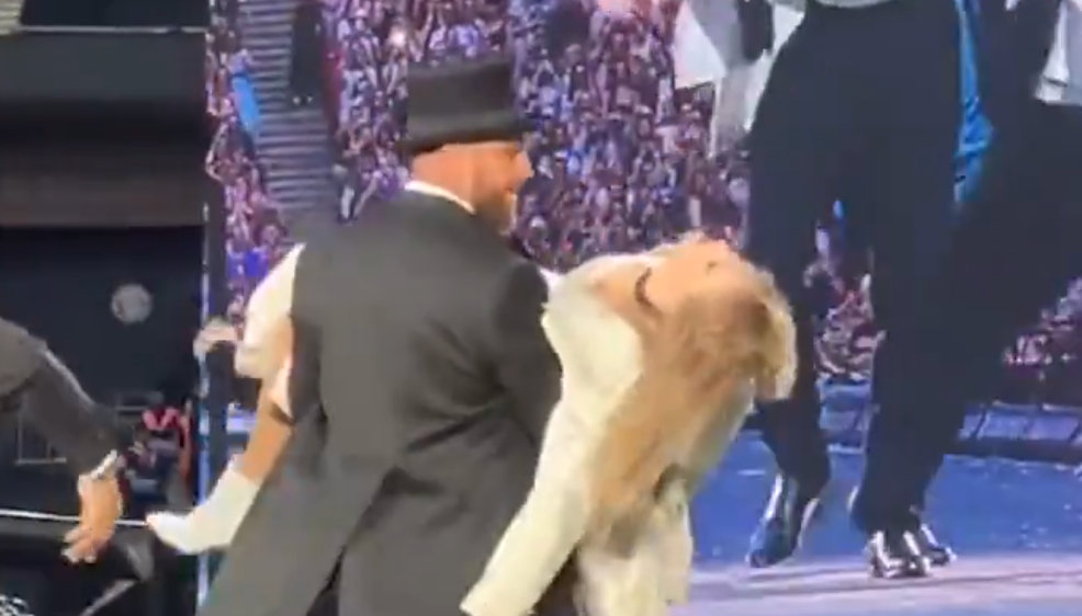 Travis Kelce with Taylor Swift on stage at the Eras Tour