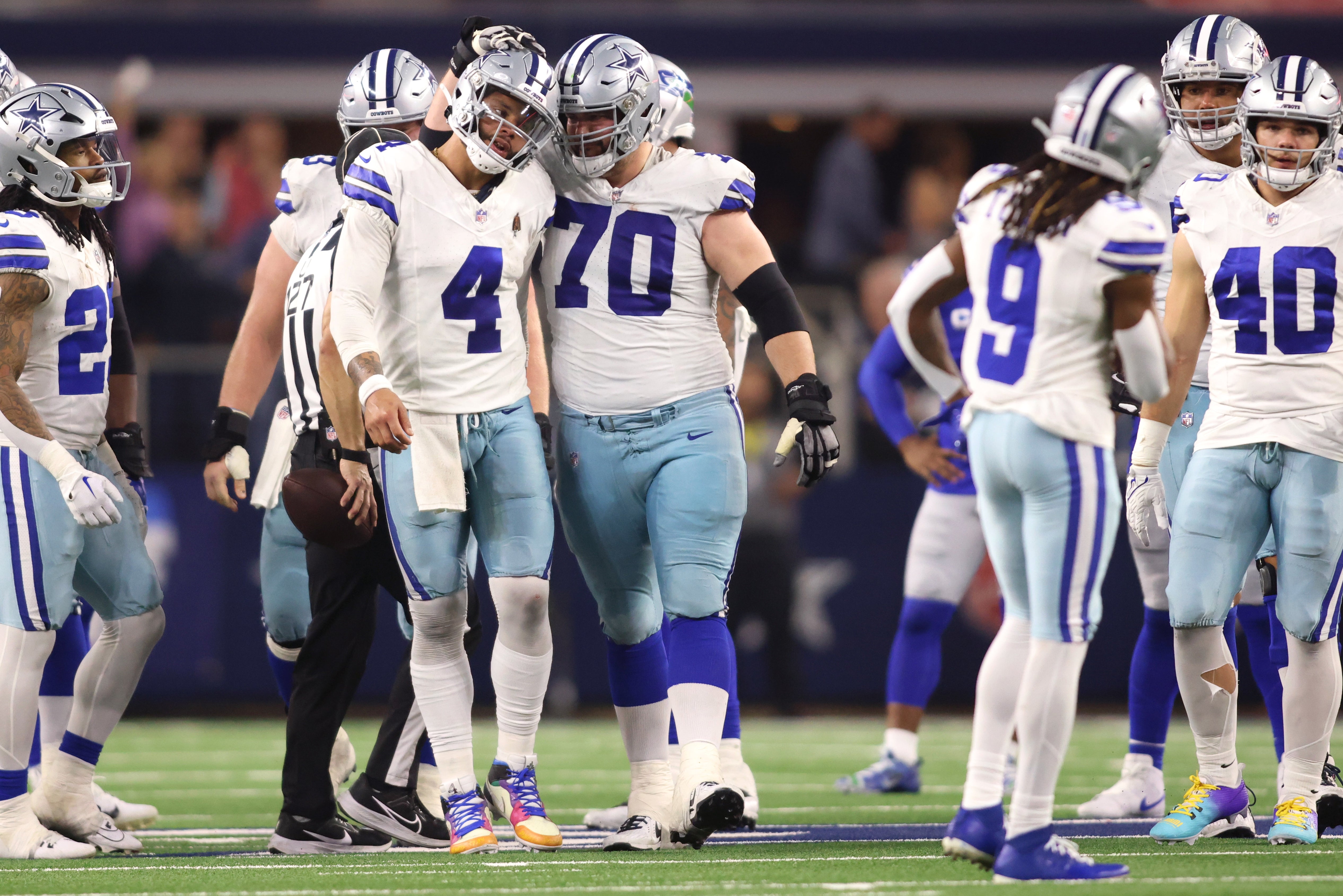 Dallas Cowboys quarterback Dak Prescott (4) and guard Zack Martin (70) celebrate during the second half against the Seattle Seahawks at AT&T Stadium.