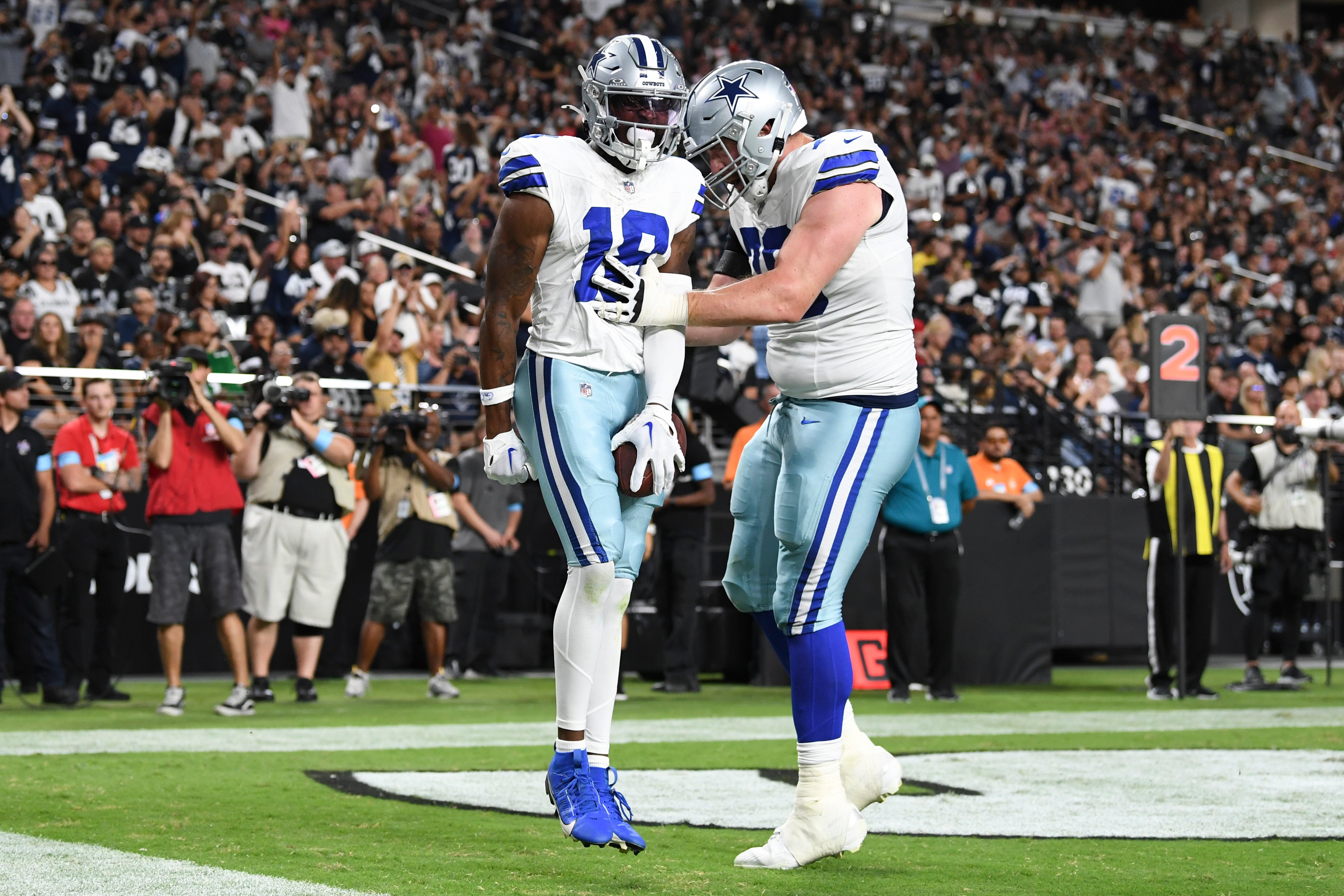 Dallas Cowboys wide receiver Ryan Flournoy (18) celebrates scoring a touchdown with offensive tackle Matt Waletzko (79) in the second quarter against the Las Vegas Raiders at Allegiant Stadium.