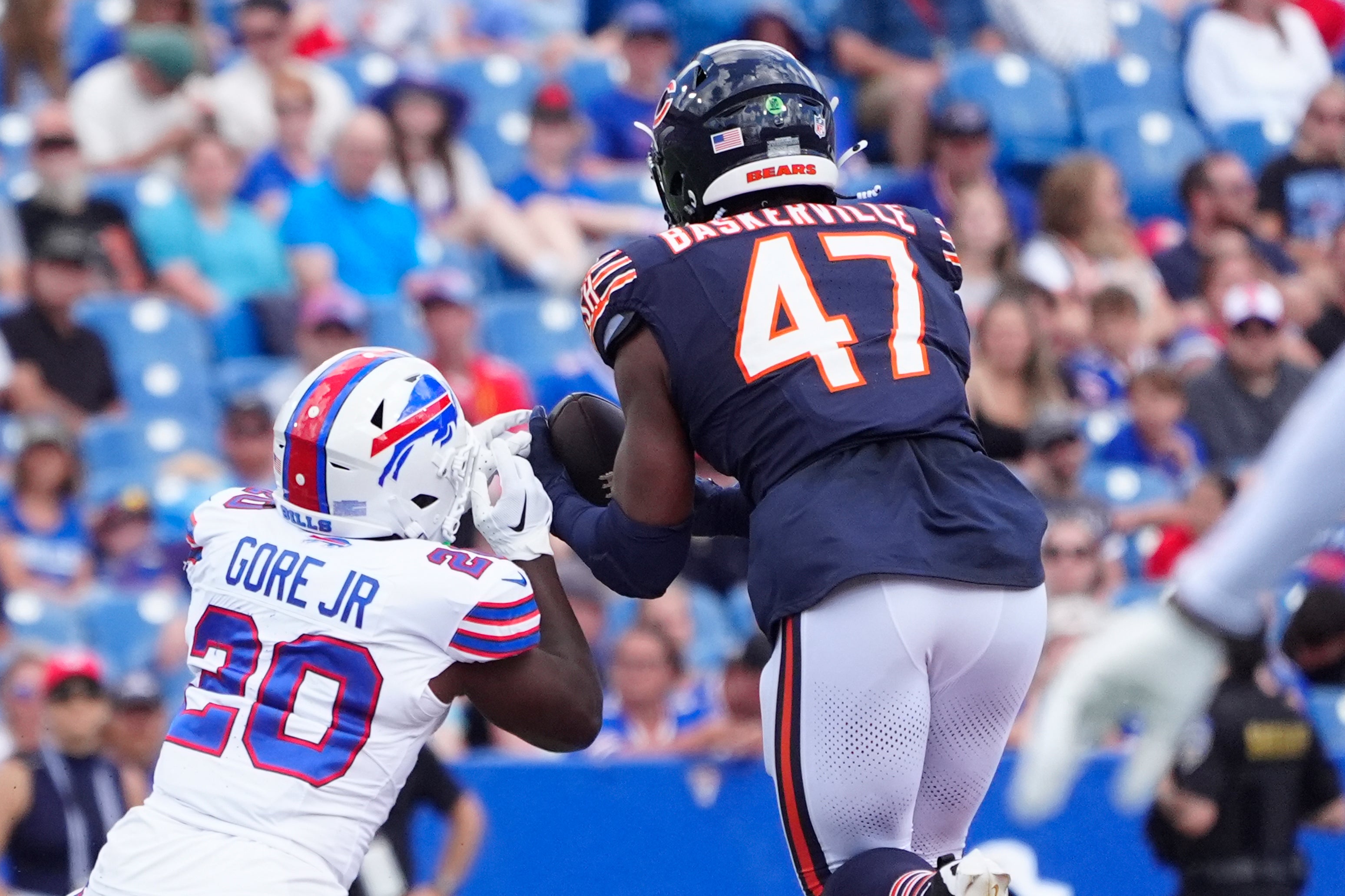 Aug 10, 2024; Orchard Park, New York, USA; Chicago Bears linebacker Micah Baskerville (47) intercepts a pass intended for Buffalo Bills running back Frank Gore Jr. (20) during the second half at Highmark Stadium.