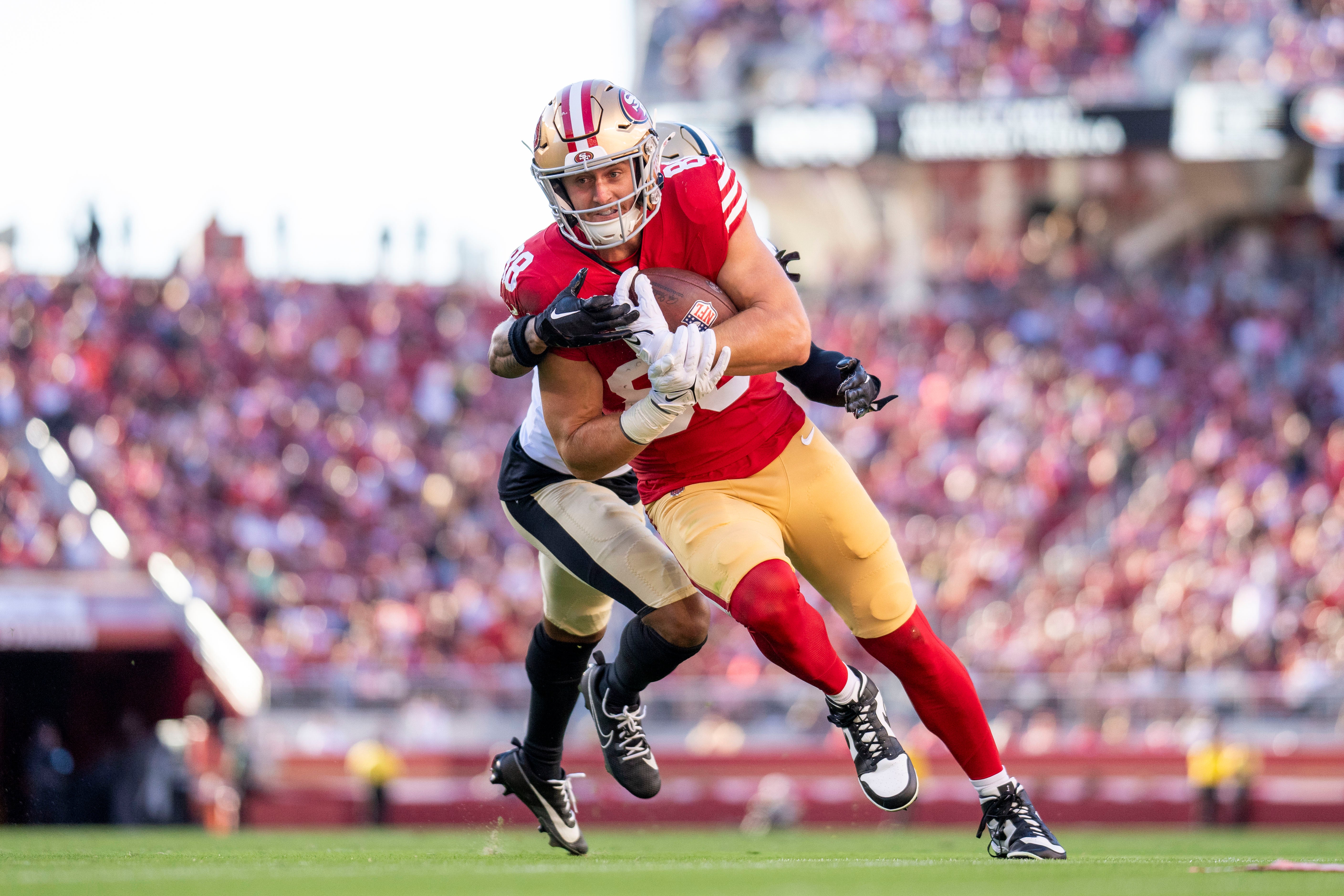 August 18, 2024; Santa Clara, California, USA; San Francisco 49ers tight end Jake Tonges (88) runs the football against New Orleans Saints cornerback Rico Payton (36) during the second quarter at Levi's Stadium.