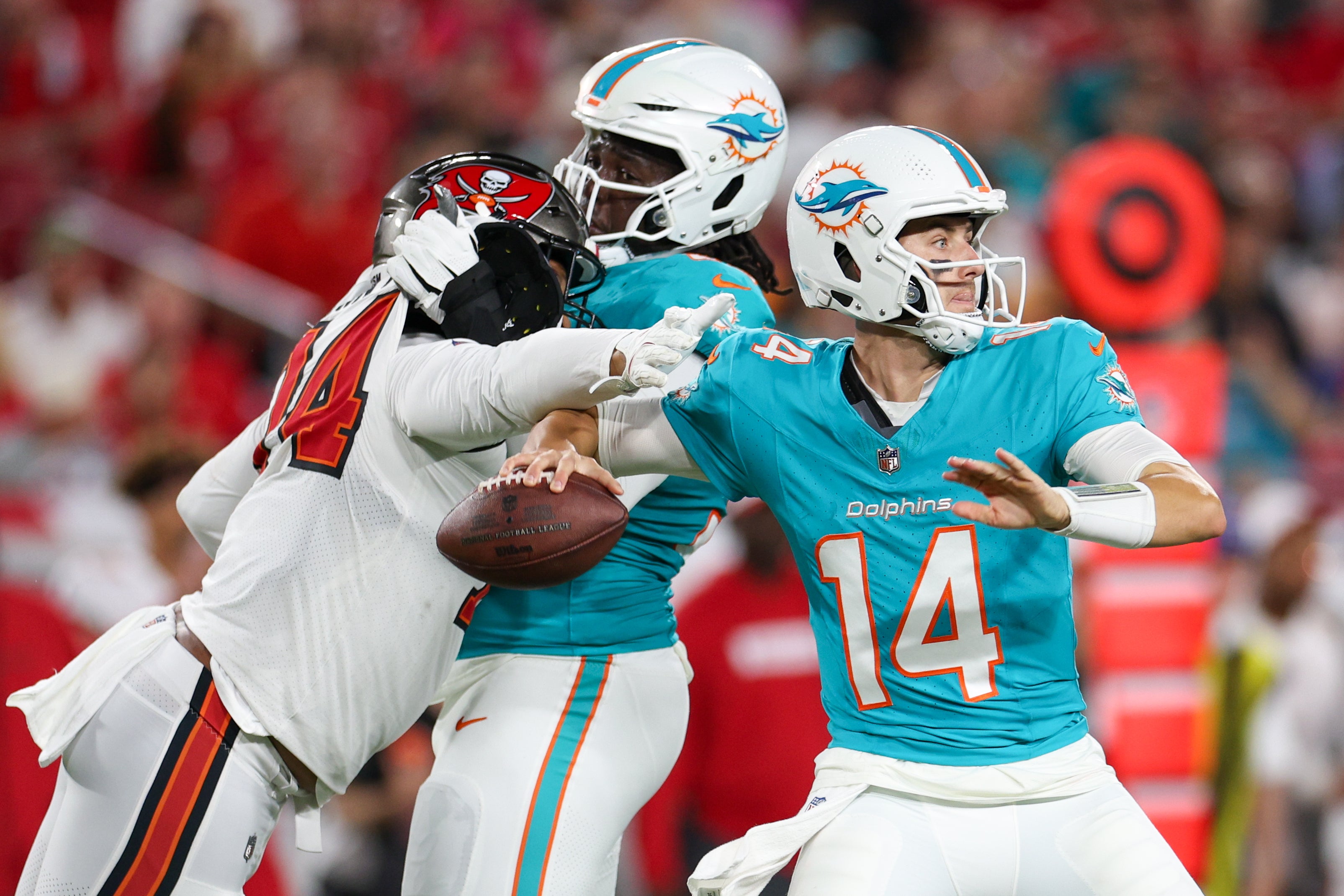 Aug 23, 2024; Tampa, Florida, USA; Tampa Bay Buccaneers defensive lineman Earnest Brown IV (74) pressures Miami Dolphins quarterback Mike White (14) in the second quarter during preseason at Raymond James Stadium.