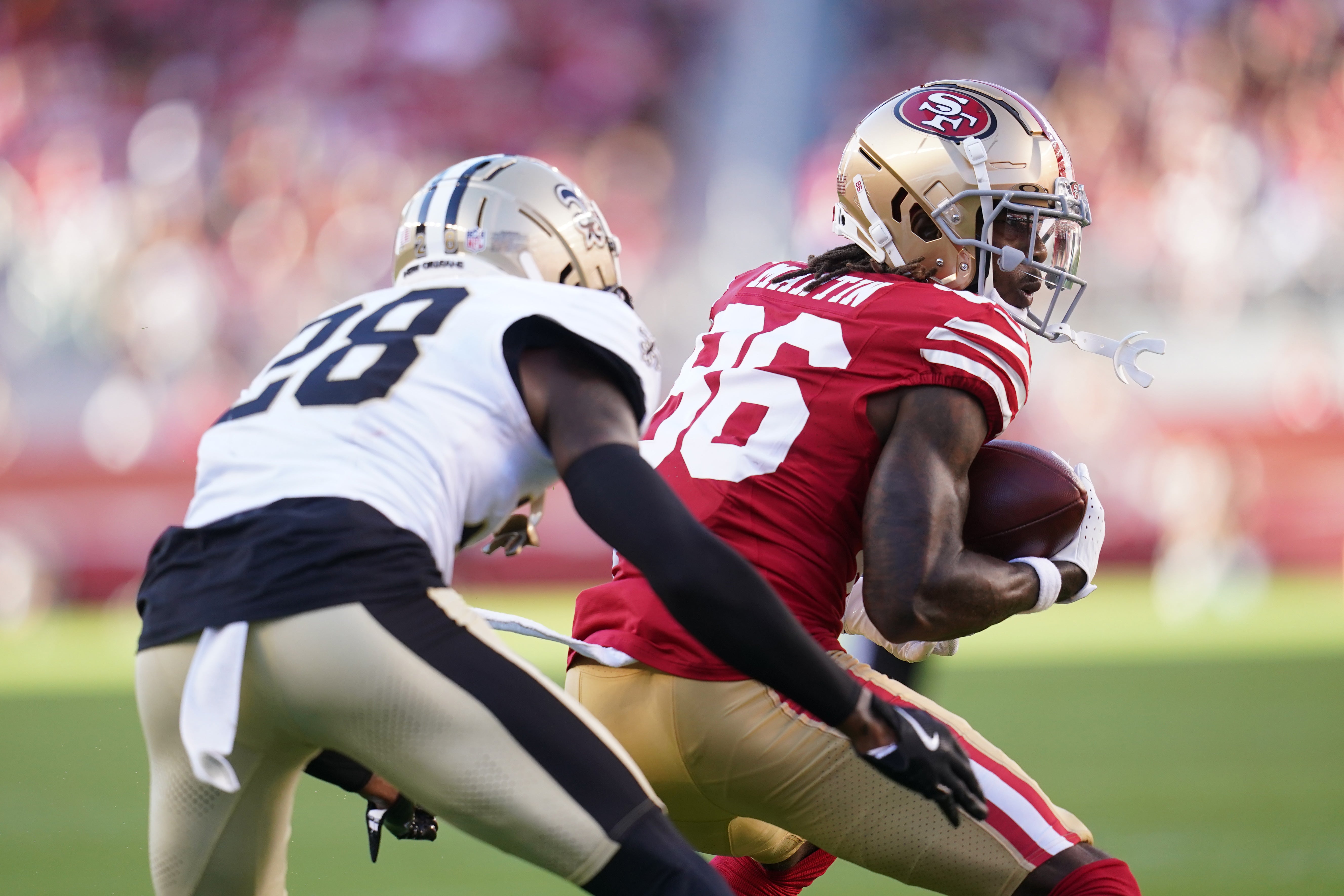 Aug 18, 2024; Santa Clara, California, USA; San Francisco 49ers wide receiver Tay Martin (86) holds onto the ball after making a catch in front of New Orleans Saints cornerback Rejzohn Wright (28) in the second quarter at Levi's Stadium.