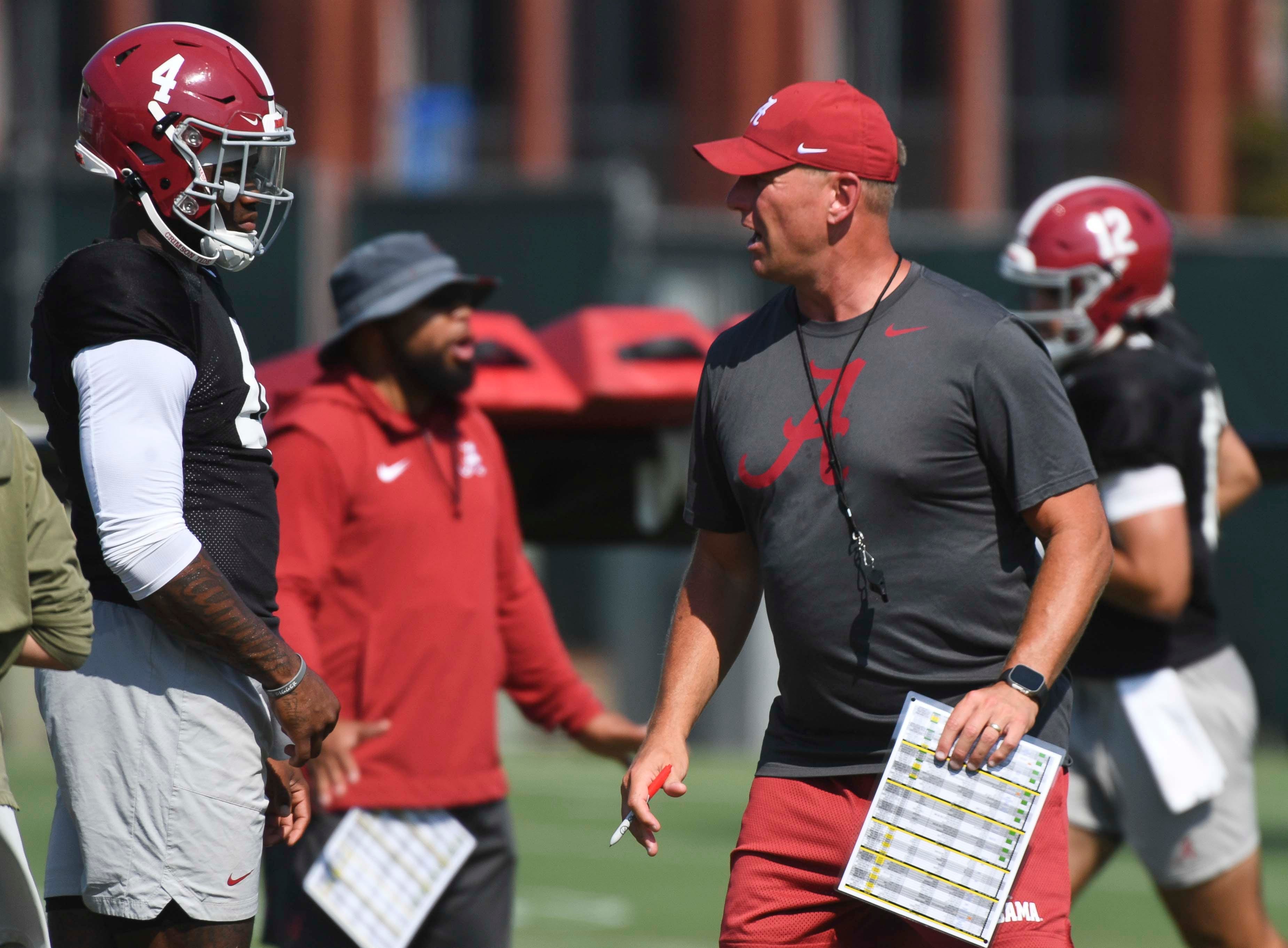 The Alabama Crimson Tide football team works out Sunday morning in practice as they prepare for the 2024 season. Alabama quarterback Jalen Milroe (4) listens to directions from Alabama head coach Kalen DeBoer.  
