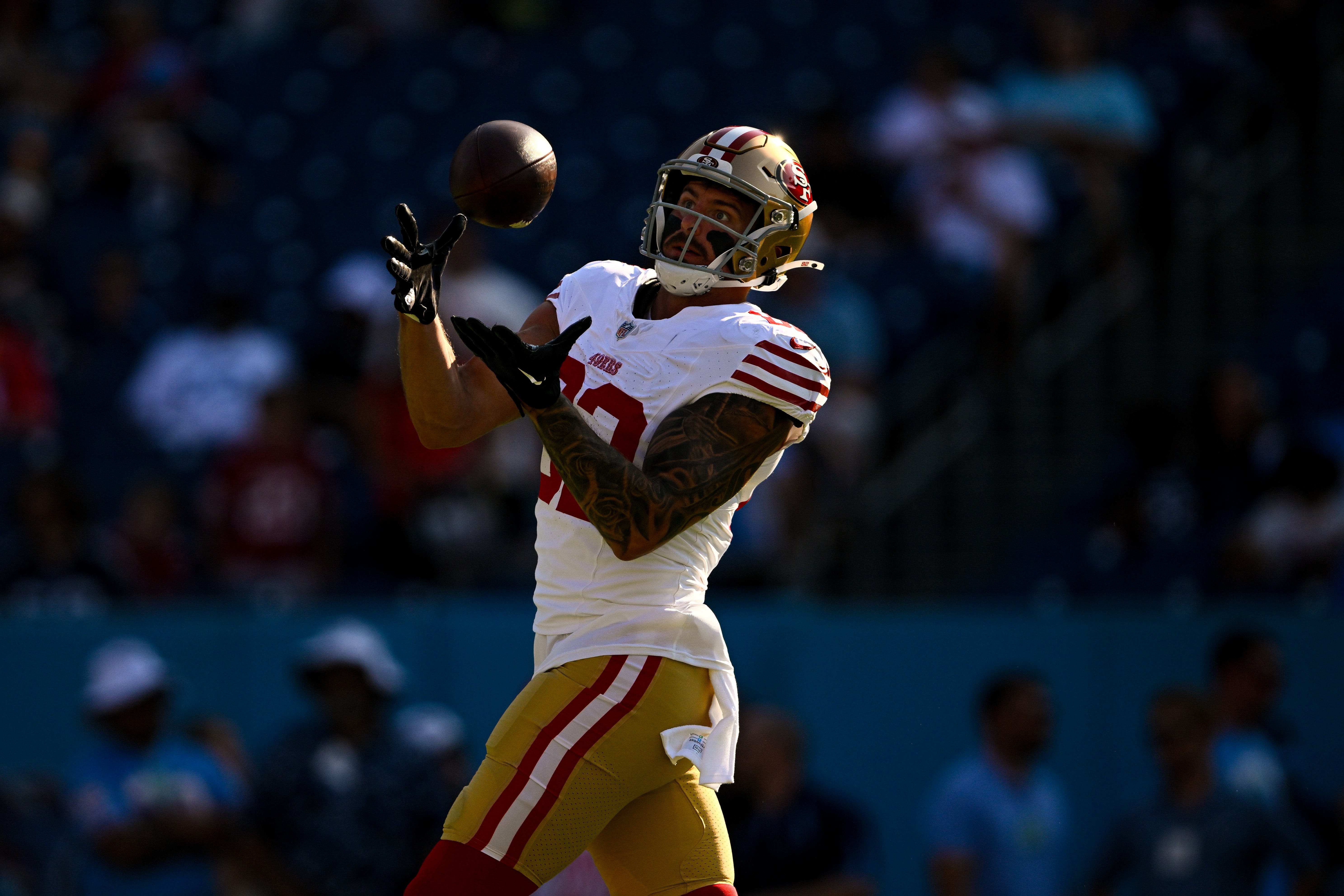 Aug 10, 2024; Nashville, Tennessee, USA; San Francisco 49ers tight end Eric Saubert (82) makes a catch against the Tennessee Titans during pregame warmups at Nissan Stadium.