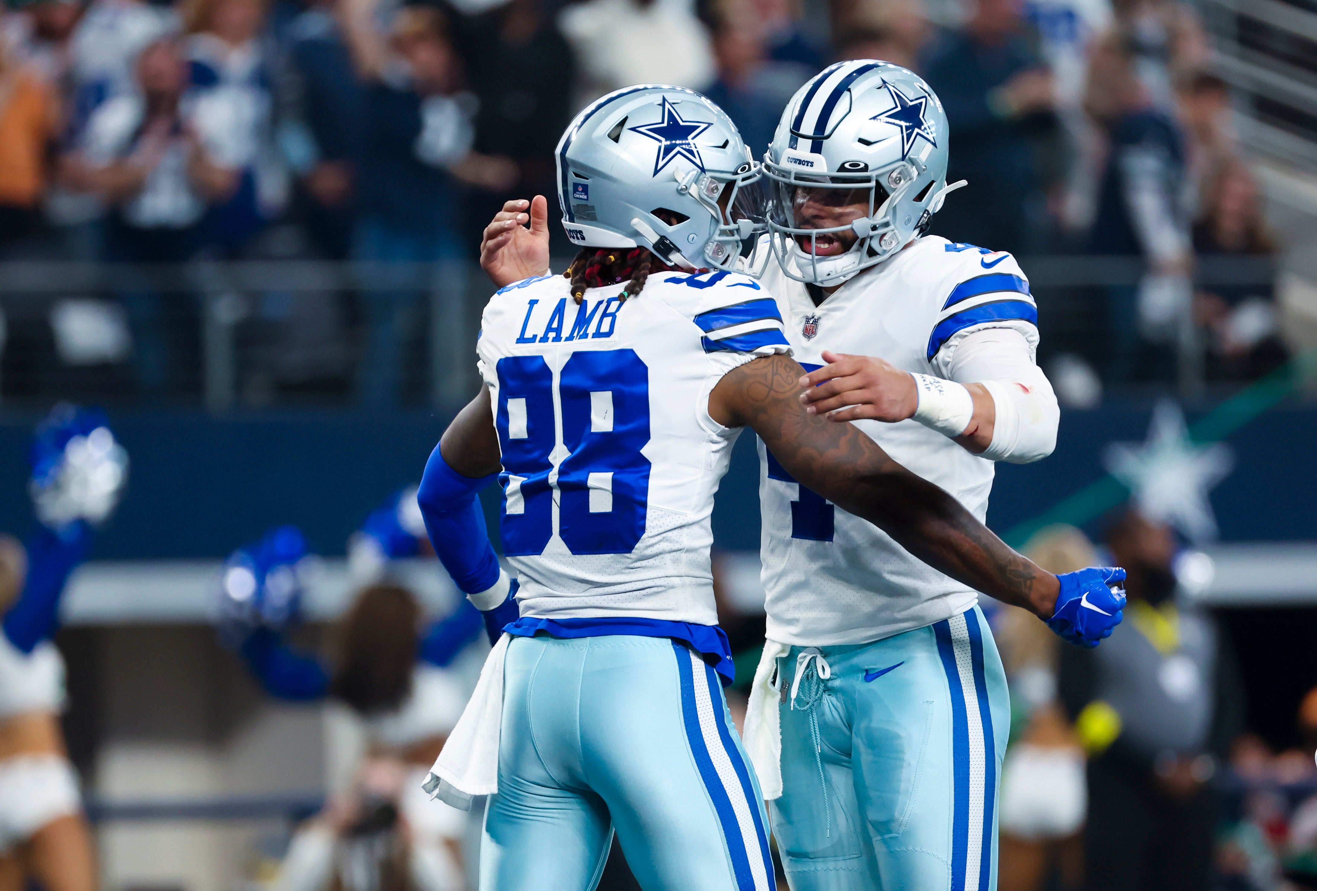 Dallas Cowboys wide receiver CeeDee Lamb (88) celebrates with Dallas Cowboys quarterback Dak Prescott (4) after scoring a touchdown during the first half against the Philadelphia Eagles at AT&T Stadium.