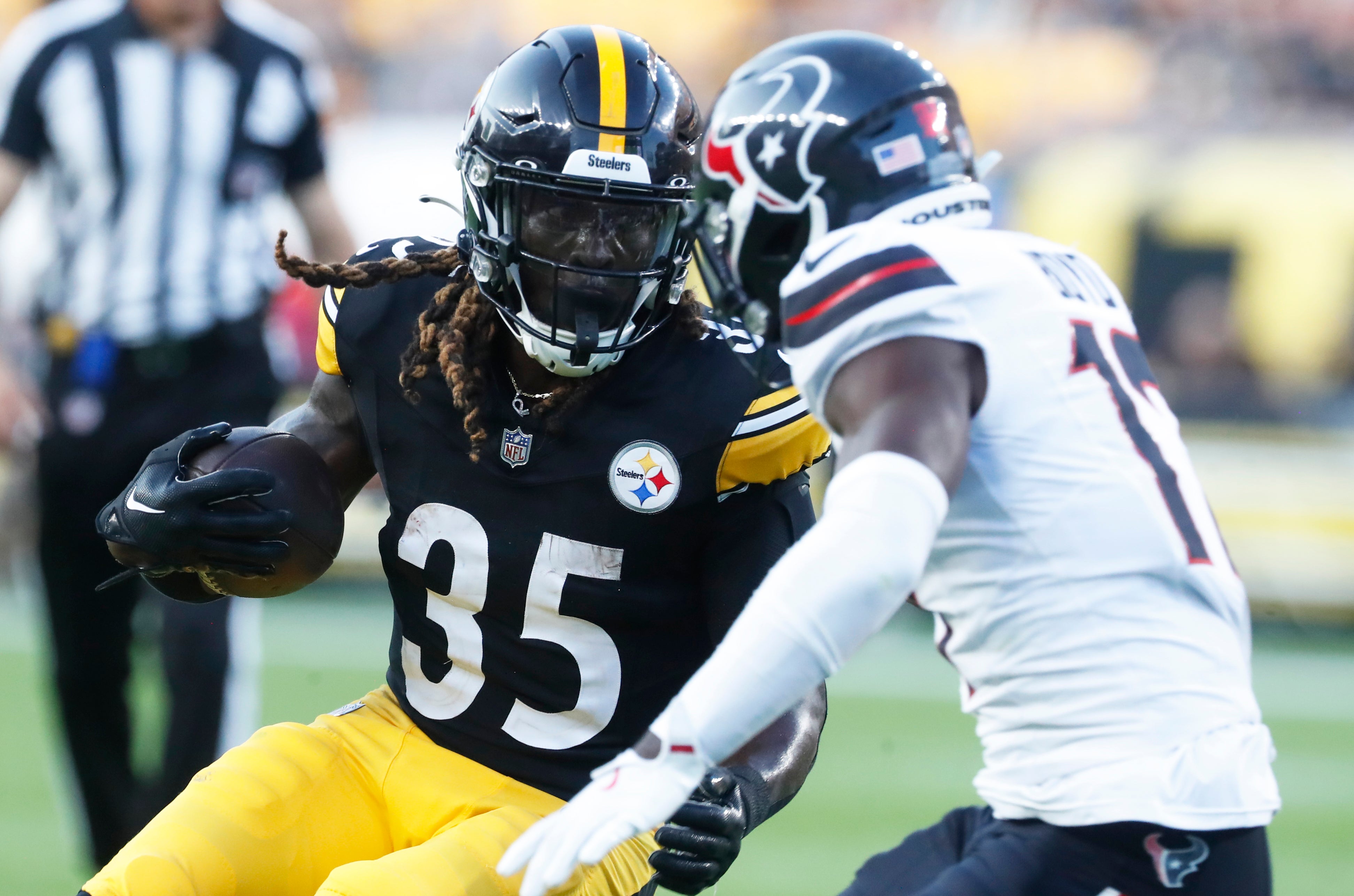 Aug 9, 2024; Pittsburgh, Pennsylvania, USA; Pittsburgh Steelers running back Jonathan Ward (35) runs the ball as Houston Texans cornerback Kris Boyd (17) defends during the second quarter at Acrisure Stadium. Mandatory Credit: Charles LeClaire-USA TODAY Sports