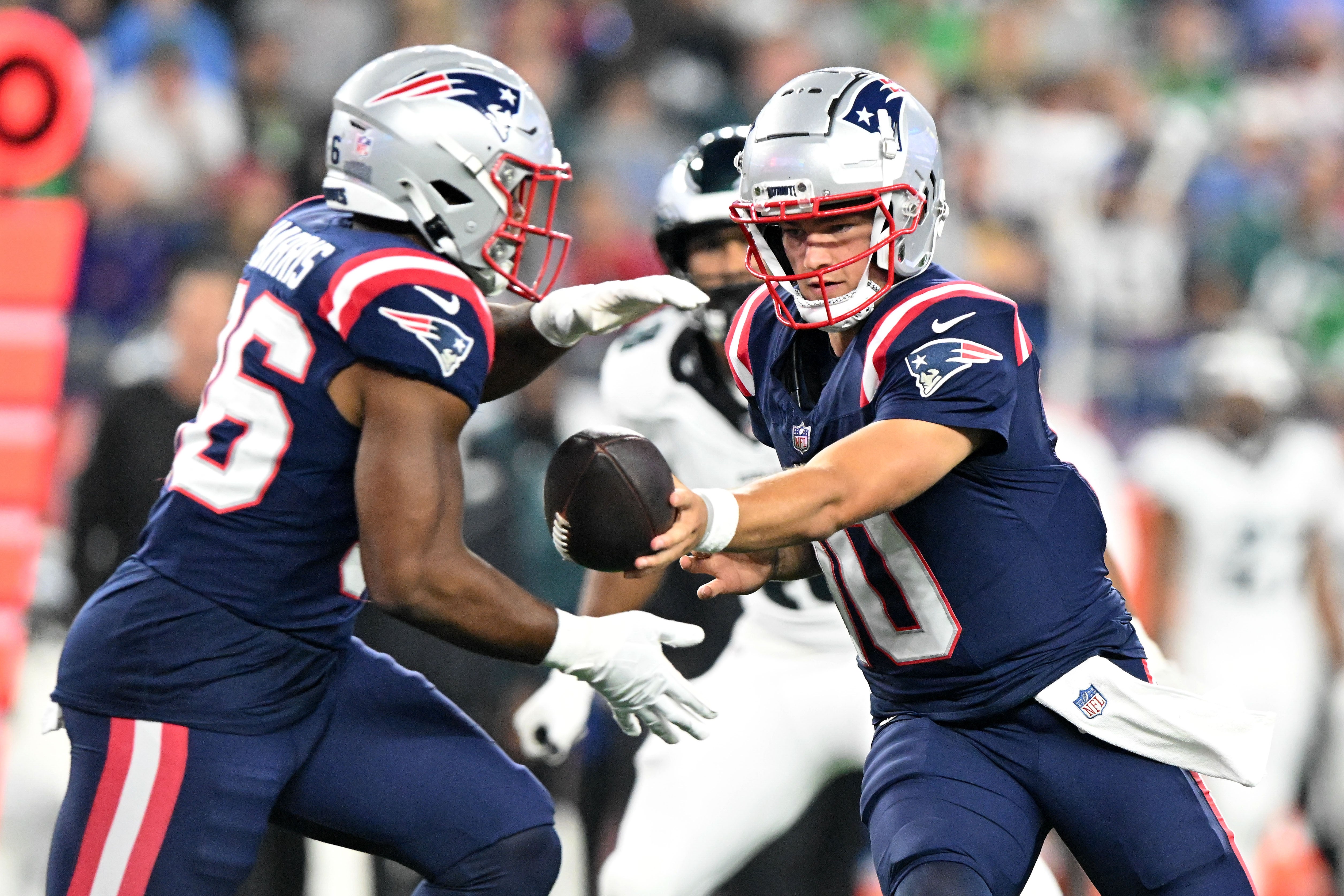 Aug 15, 2024; Foxborough, Massachusetts, USA; New England Patriots quarterback Drake Maye (10) hands the ball off to running back Kevin Harris (36) during the second half at Gillette Stadium.