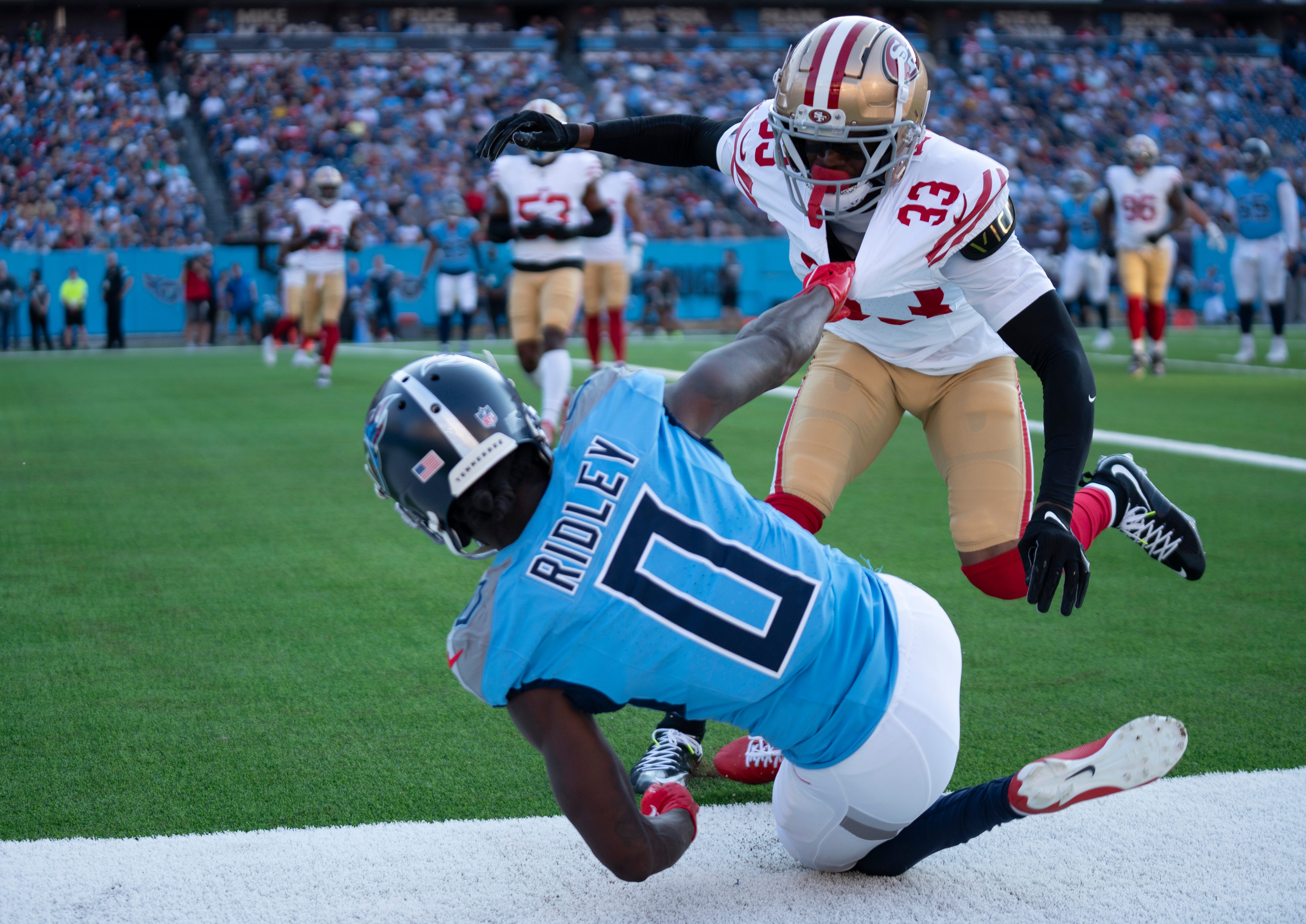 Tennessee Titans wide receiver Calvin Ridley (0) pulls San Francisco 49ers cornerback Rock Ya-Sin (33) down in the end zone during their first preseason game of the 2024-25 season at Nissan Stadium Saturday, Aug. 10, 2024.