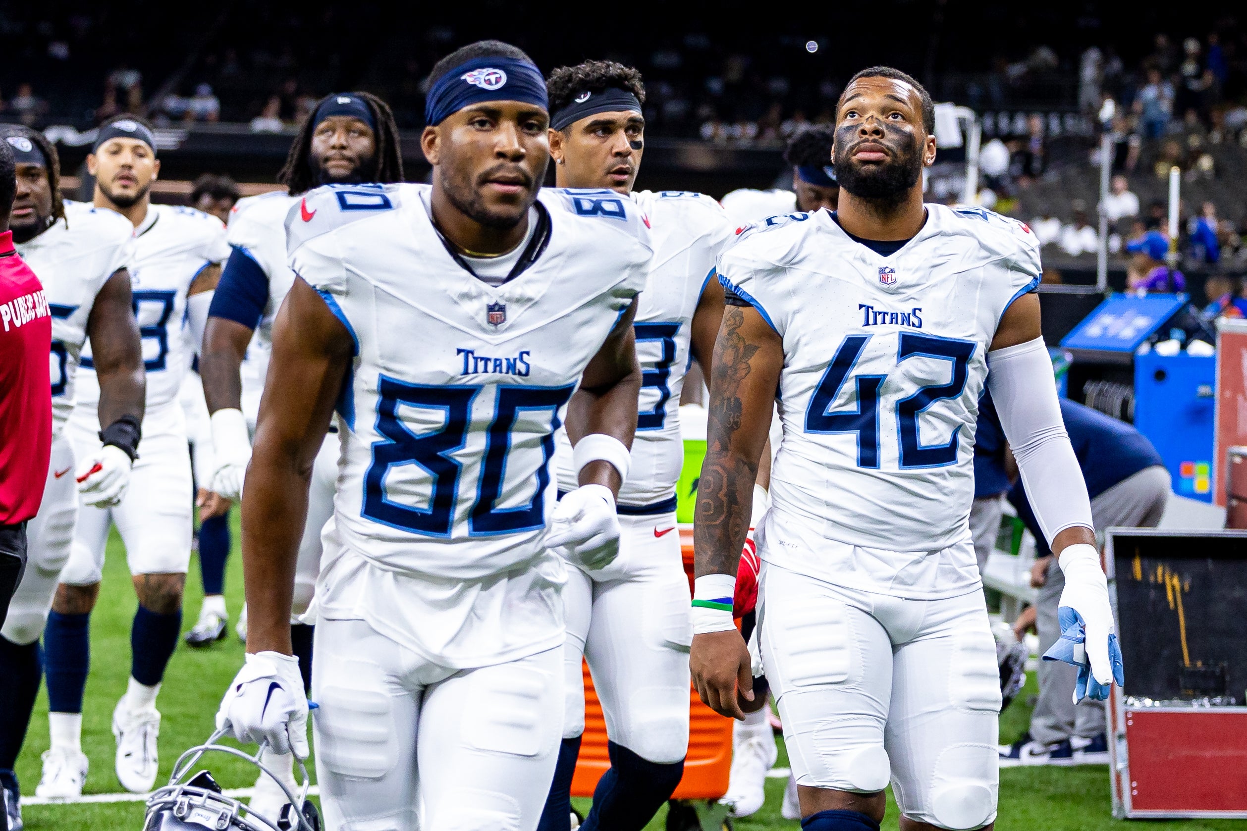 Tennessee Titans wide receiver Bryce Oliver (80) and linebacker Caleb Murphy (42) during the warmups before the game against the New Orleans Saints at Caesars Superdome. Stephen Lew-USA TODAY Sports