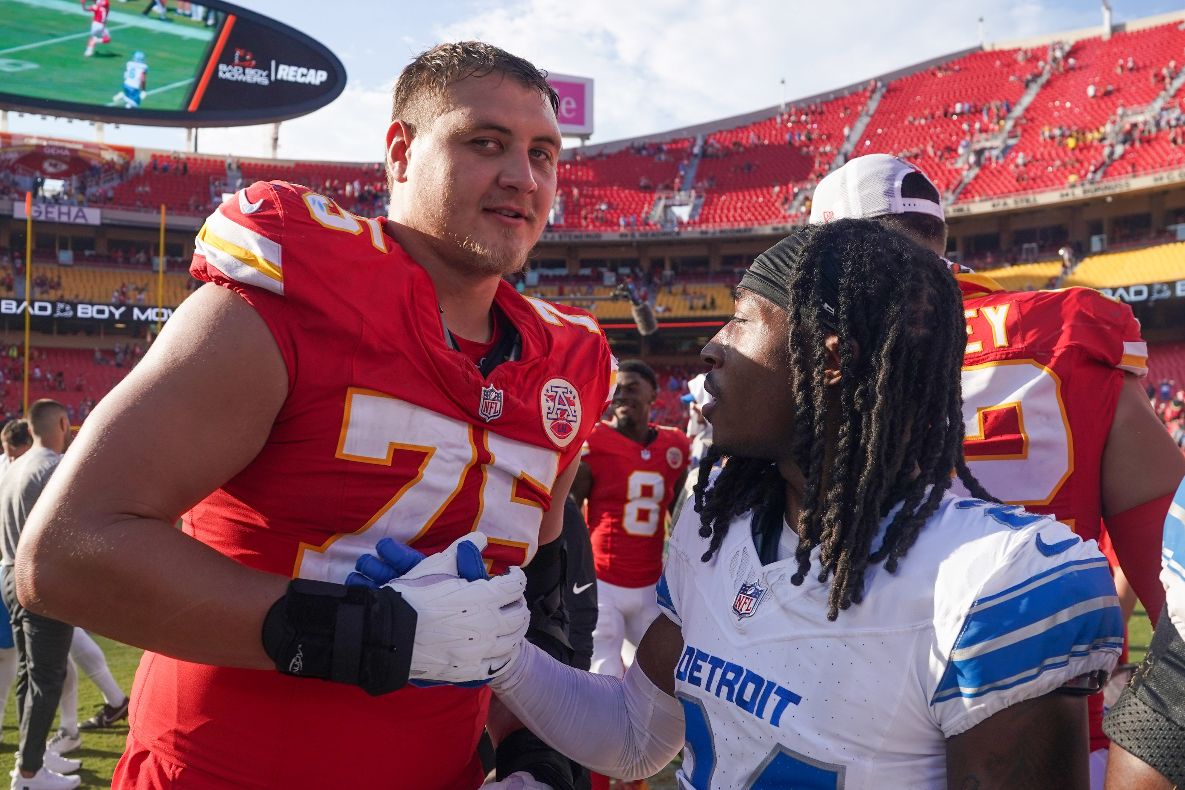 Aug 17, 2024; Kansas City, Missouri, USA; Kansas City Chiefs offensive tackle Ethan Driskell (75) and Detroit Lions cornerback Steven Gilmore (24) shake hands after the game the game at GEHA Field at Arrowhead Stadium.
