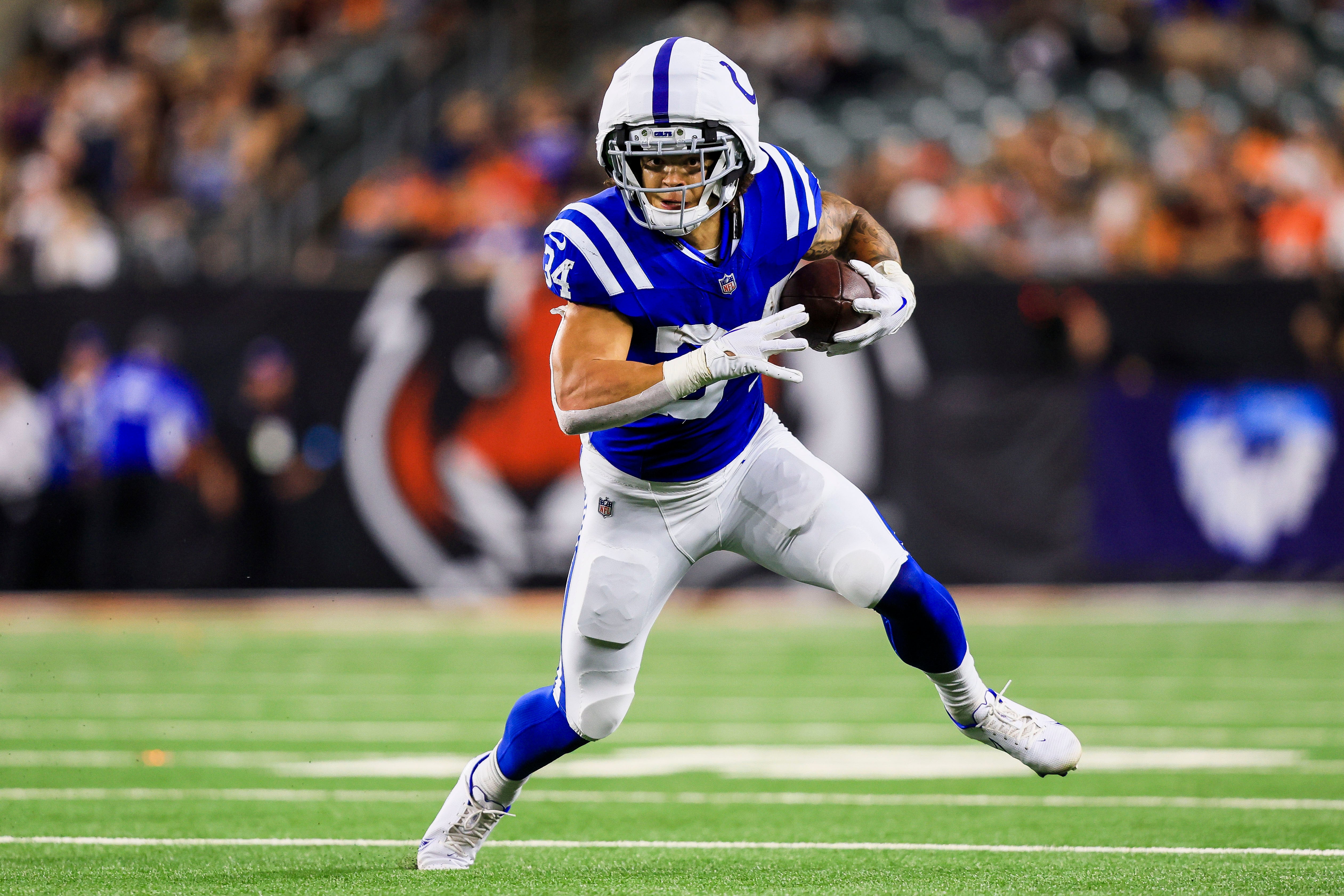 Aug 22, 2024; Cincinnati, Ohio, USA; Indianapolis Colts running back Zavier Scott (34) runs with the ball against the Cincinnati Bengals in the second half at Paycor Stadium.