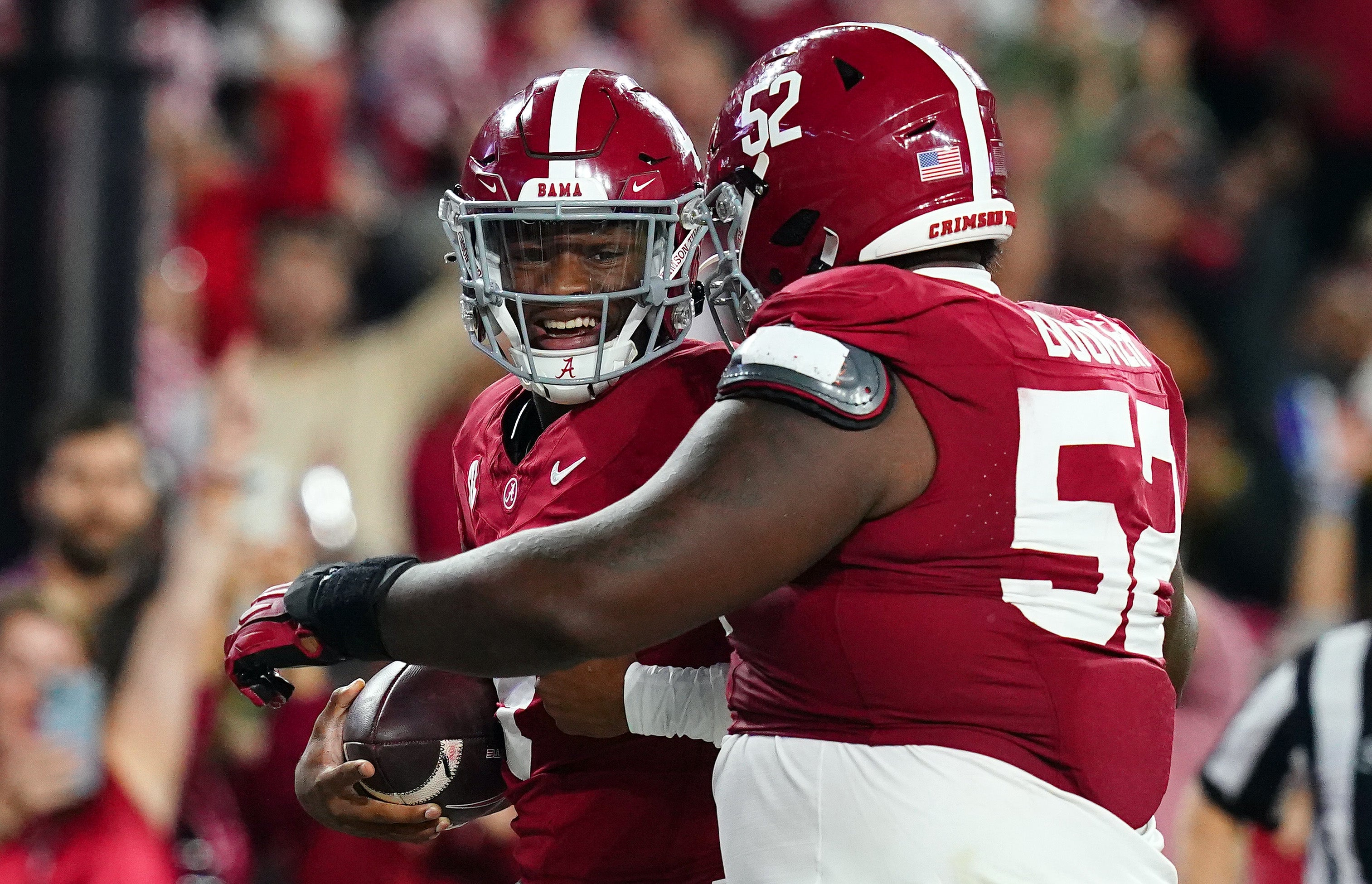 Nov 4, 2023; Tuscaloosa, Alabama, USA; Alabama Crimson Tide quarterback Jalen Milroe (4) celebrates his touchdown against the LSU Tigers with offensive lineman Tyler Booker (52) during the second half at Bryant-Denny Stadium. Alabama Crimson Tide defeated the LSU Tigers 42-28. Mandatory Credit: John David Mercer-USA TODAY Sports