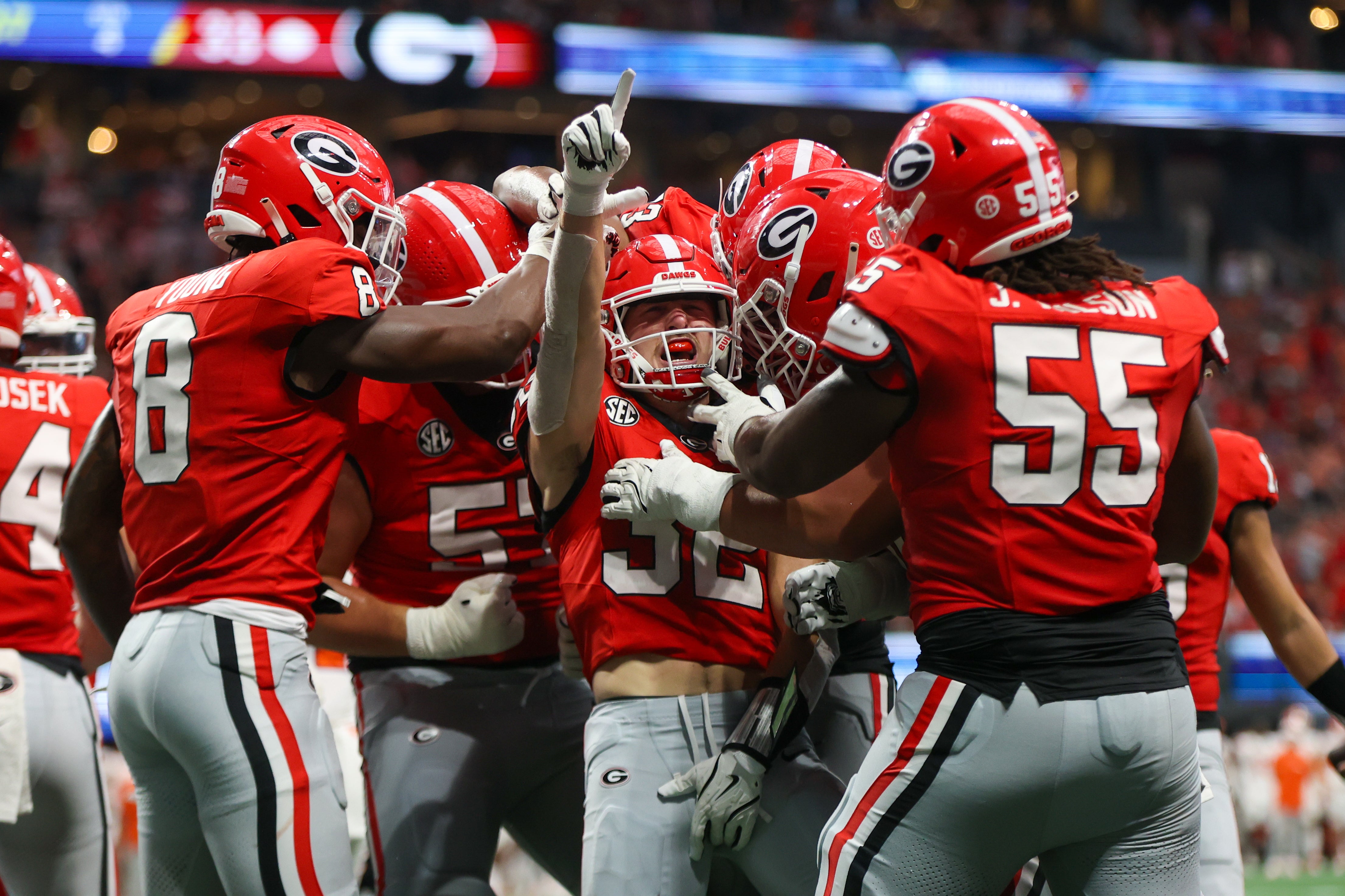 Georgia Bulldogs running back Cash Jones (32) celebrates with teammates after a touchdown against the Clemson Tigers in the third quarter at Mercedes-Benz Stadium.