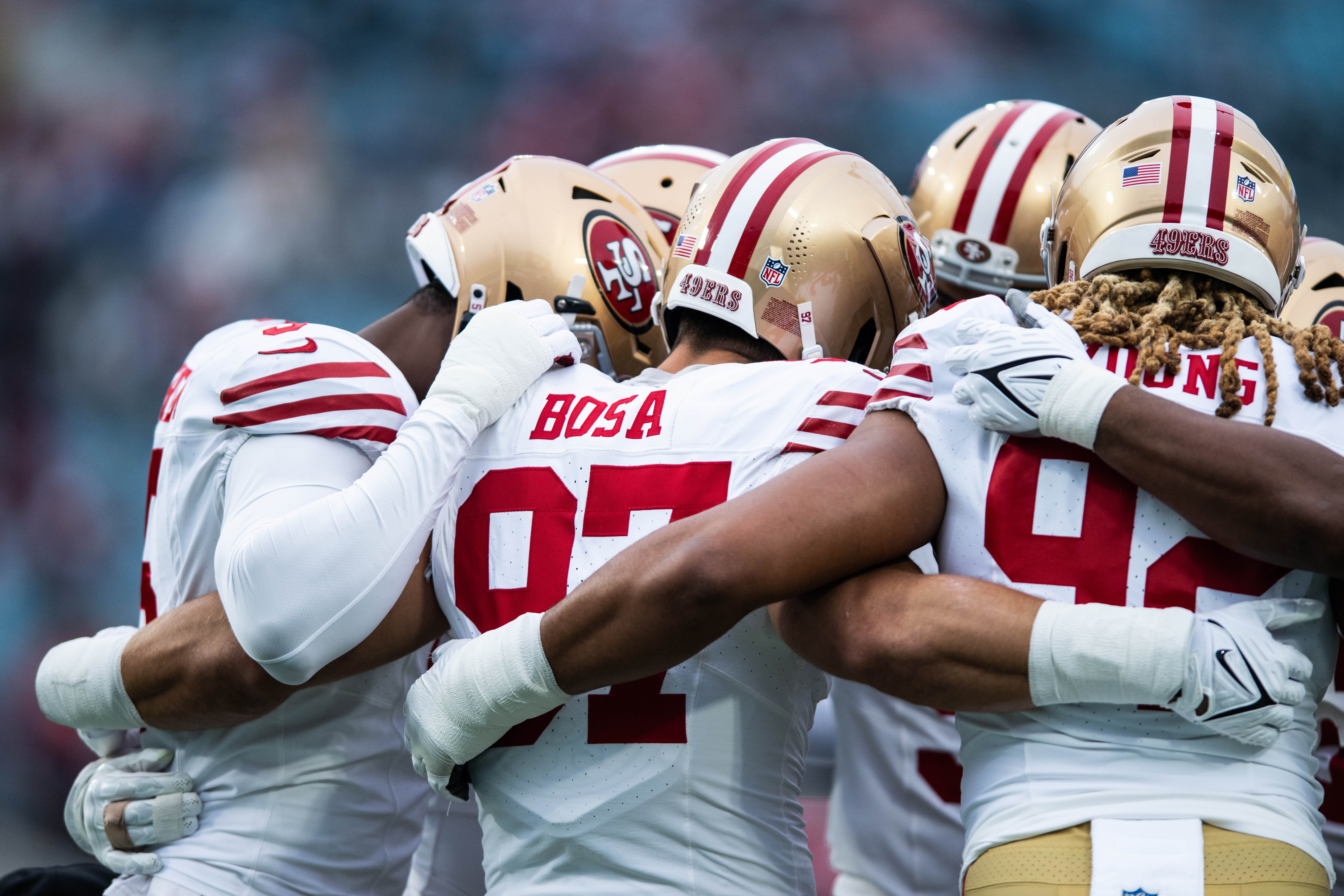 Nov 12, 2023; Jacksonville, Florida, USA; San Fransisco 49ers defensive lineman Nick Bosa (97) huddles with San Fransisco 49ers defensive lineman Chase Young (92) before the game against the Jacksonville Jaguars at EverBank Stadium.