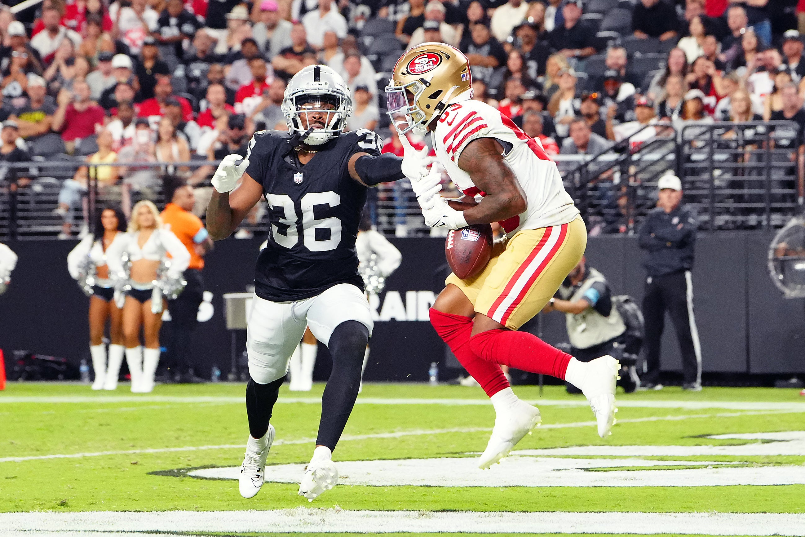 Aug 23, 2024; Paradise, Nevada, USA; San Francisco 49ers wide receiver Jacob Cowing (83) makes a touchdown catch against Las Vegas Raiders cornerback Rayshad Williams (36) during the third quarter at Allegiant Stadium.
