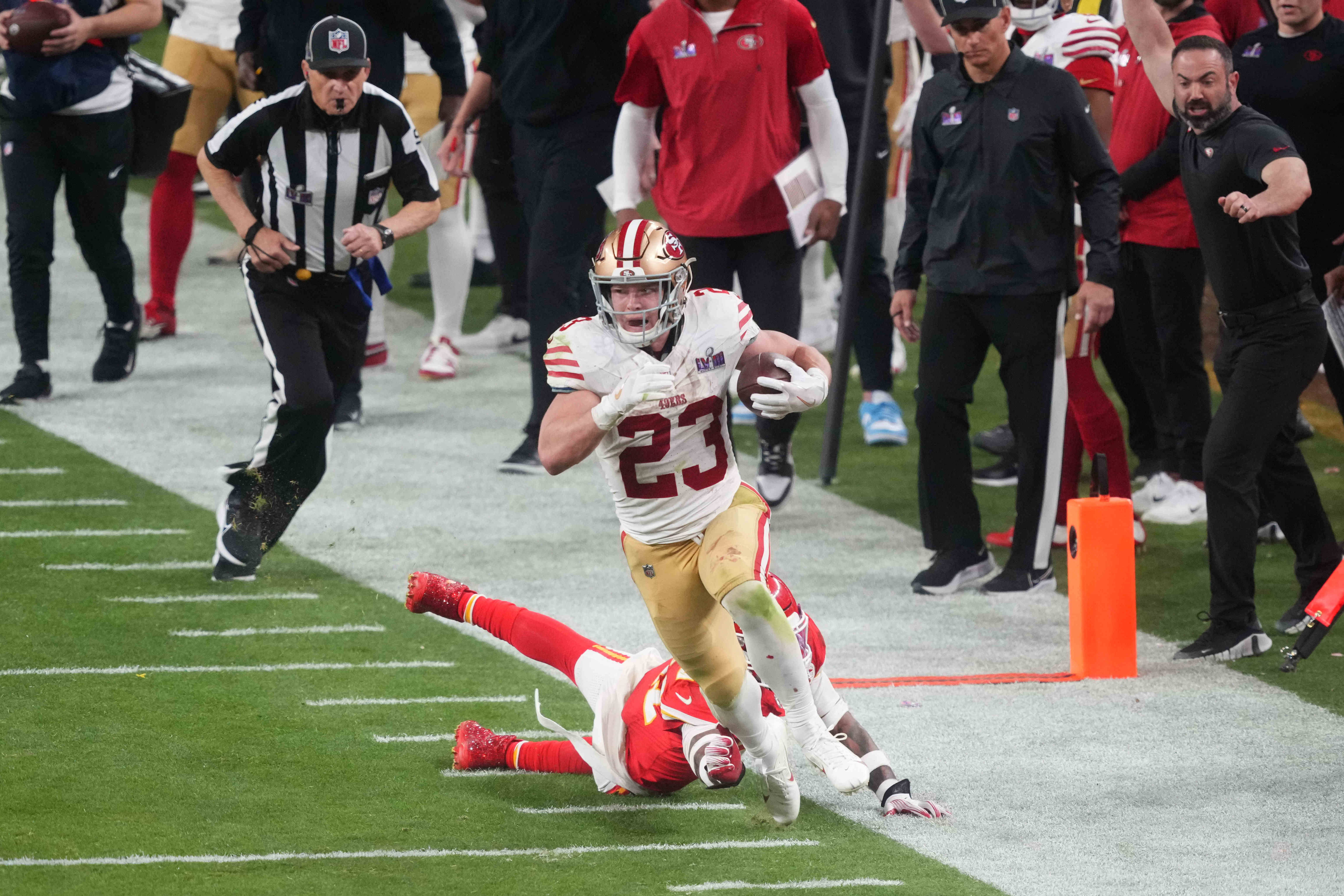Feb 11, 2024; Paradise, Nevada, USA; San Francisco 49ers running back Christian McCaffrey (23) runs with the ball against Kansas City Chiefs safety Mike Edwards (21) during overtime of Super Bowl LVIII at Allegiant Stadium.