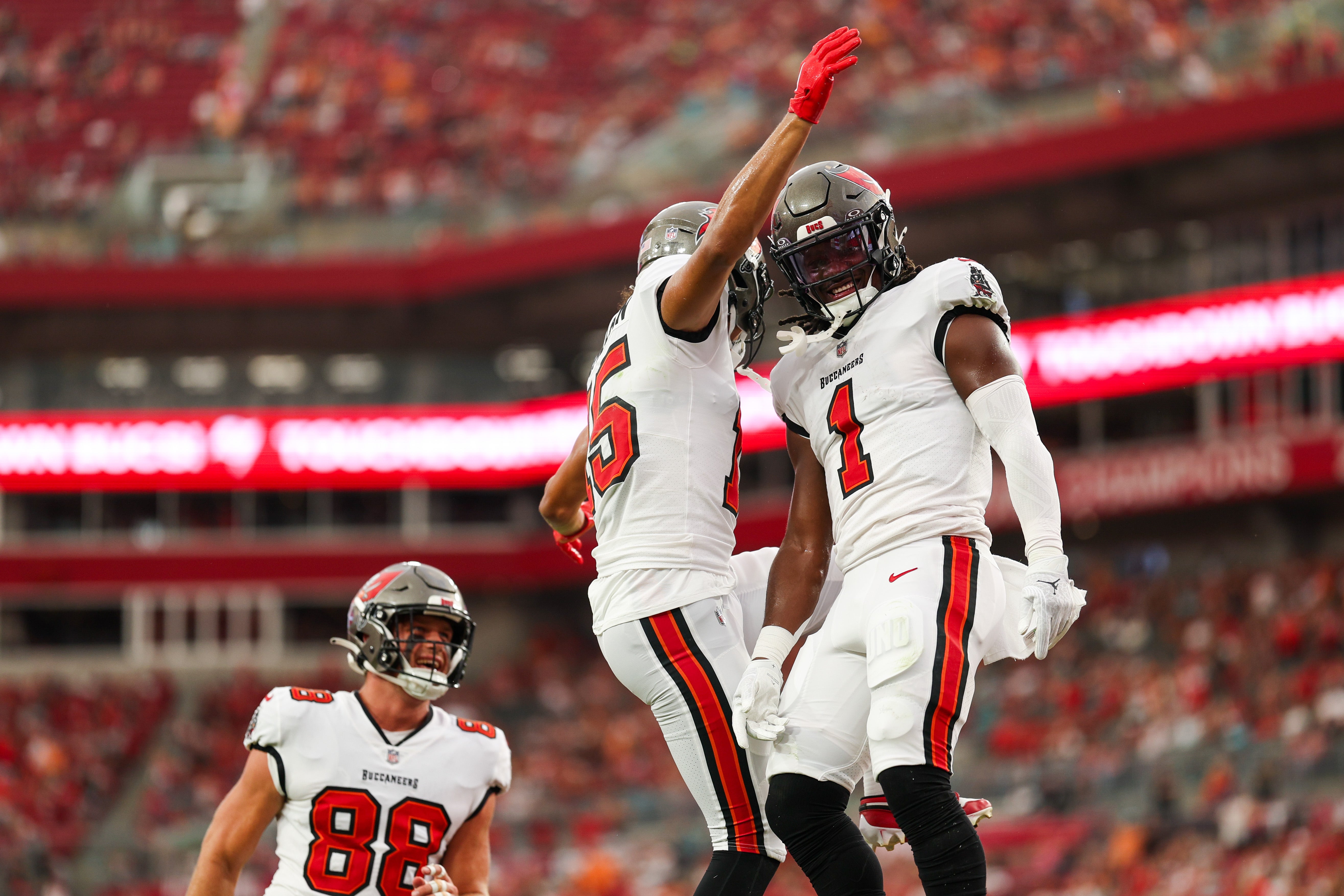 Aug 23, 2024; Tampa, Florida, USA; Tampa Bay Buccaneers running back Rachaad White (1) wide receiver Jalen McMillan (15) after scoring a touchdown against the Miami Dolphins in the first quarter during preseason at Raymond James Stadium.