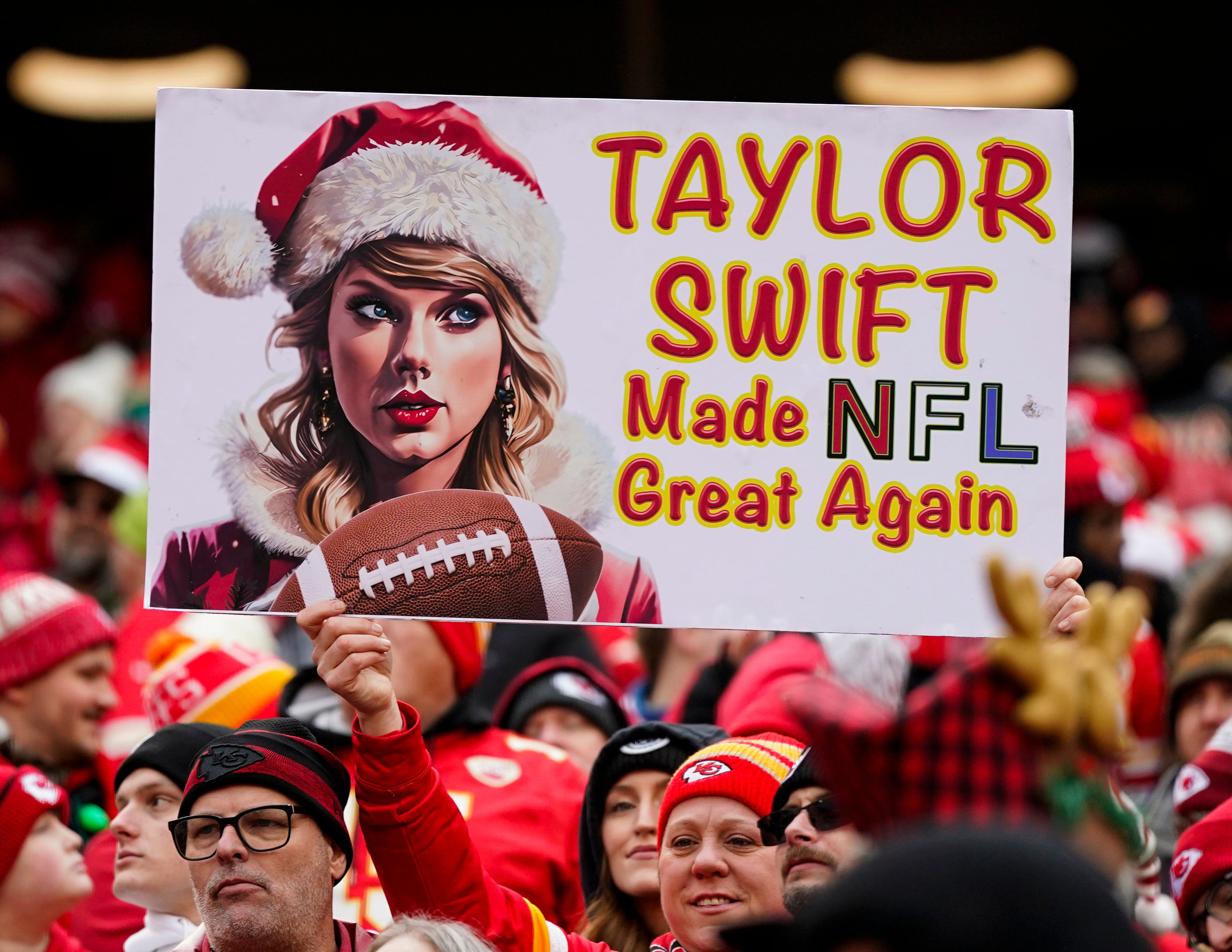 Dec 25, 2023; Kansas City, Missouri, USA; A Kansas City Chiefs fan holds a Taylor Swift sign during the first half against the Las Vegas Raiders at GEHA Field at Arrowhead Stadium.