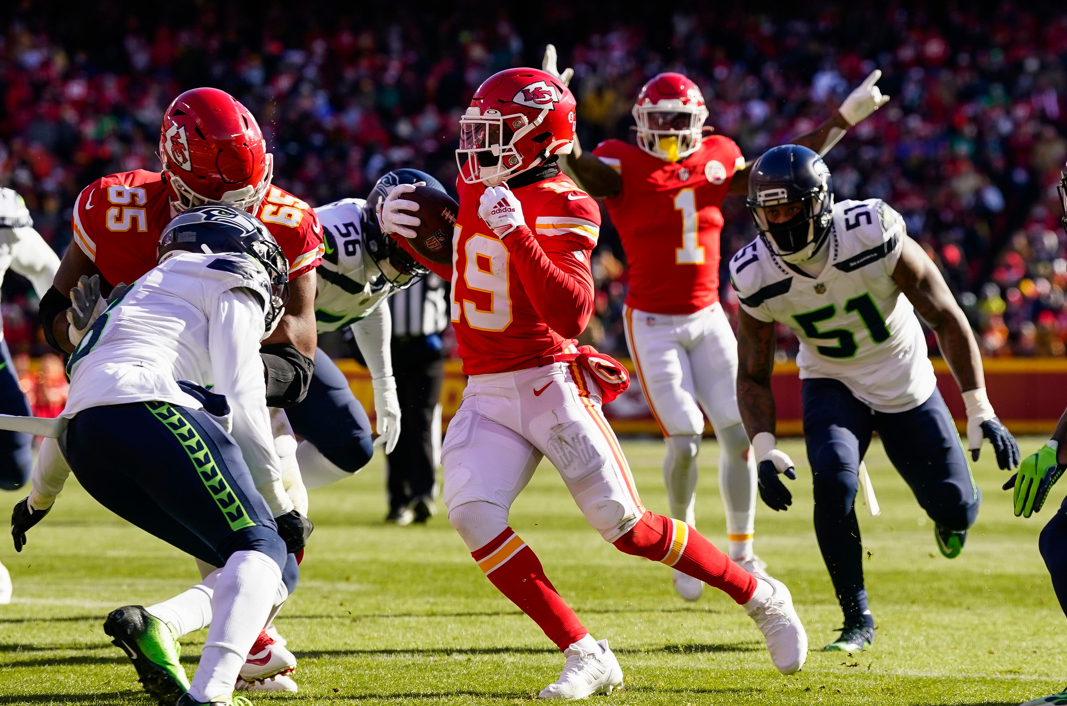 Dec 24, 2022; Kansas City, Missouri, USA; Kansas City Chiefs wide receiver Kadarius Toney (19) scores a touchdown against Seattle Seahawks cornerback Coby Bryant (8) during the first half at GEHA Field at Arrowhead Stadium.