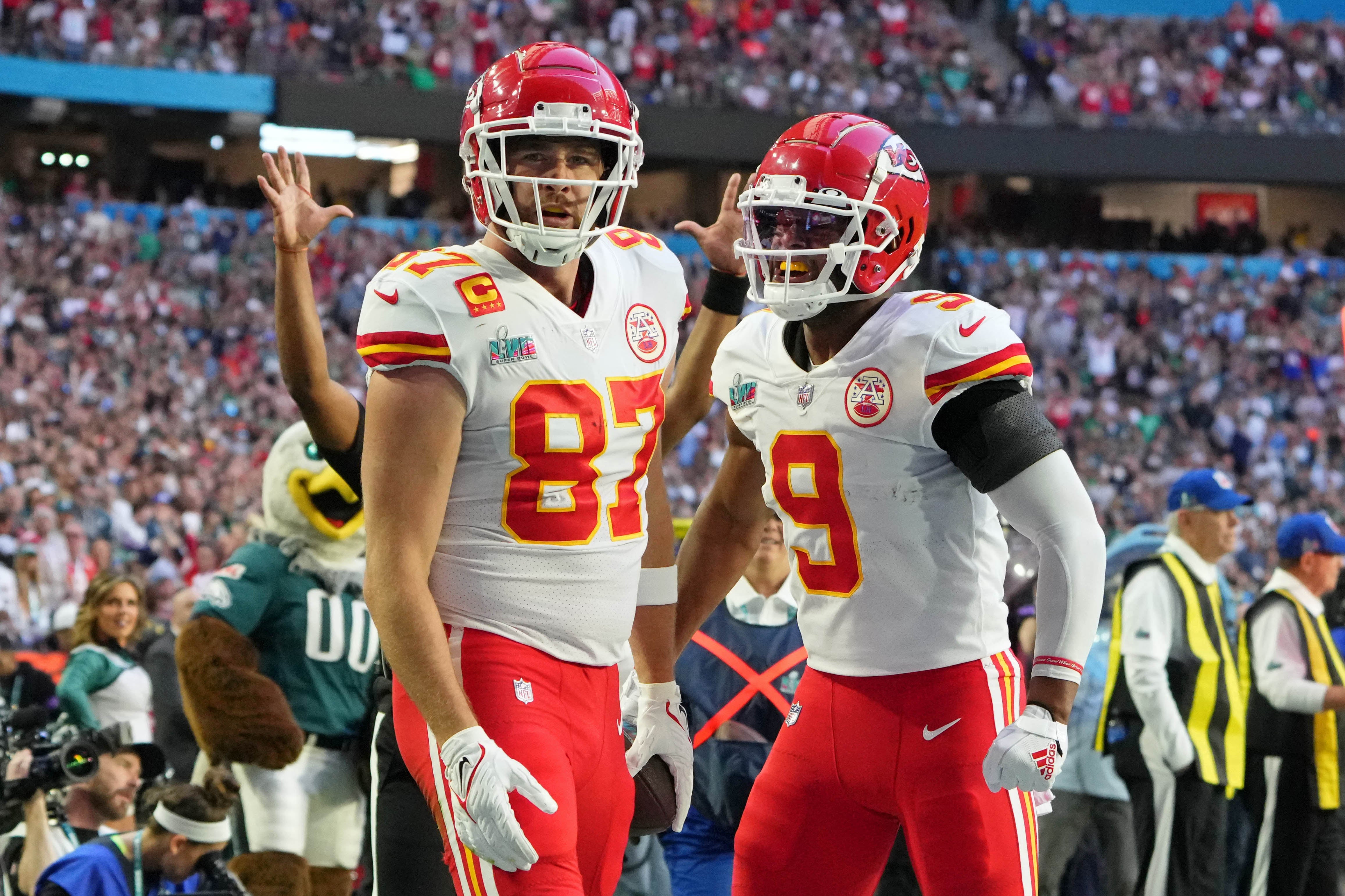 Feb 12, 2023; Glendale, Arizona, US; Kansas City Chiefs tight end Travis Kelce (87) celebrates with wide receiver JuJu Smith-Schuster (9) after making a catch for a touchdown against the Philadelphia Eagles during the first quarter of Super Bowl LVII at State Farm Stadium.