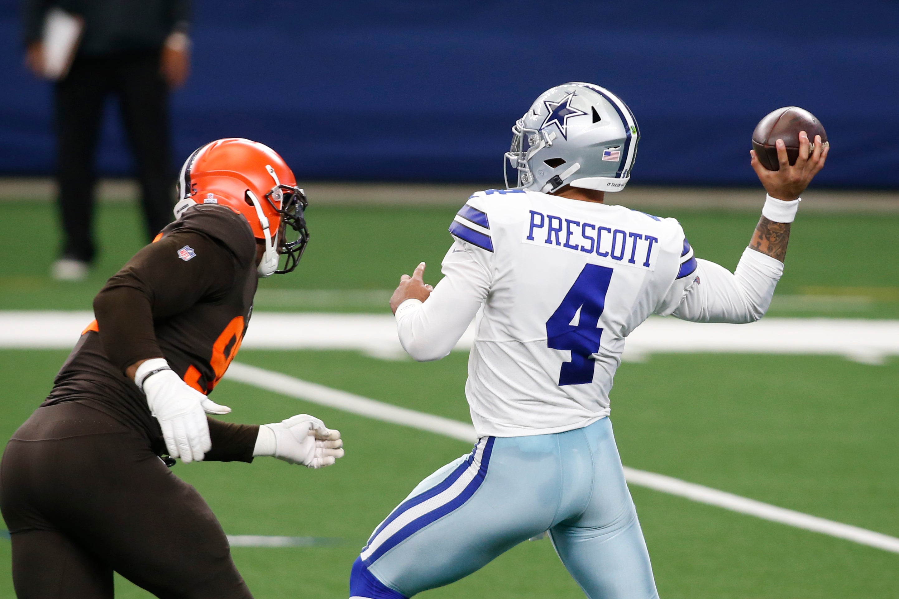 Dallas Cowboys quarterback Dak Prescott (4) drops back to pass against Cleveland Browns defensive end Myles Garrett (95) in the first quarter at AT&T Stadium.