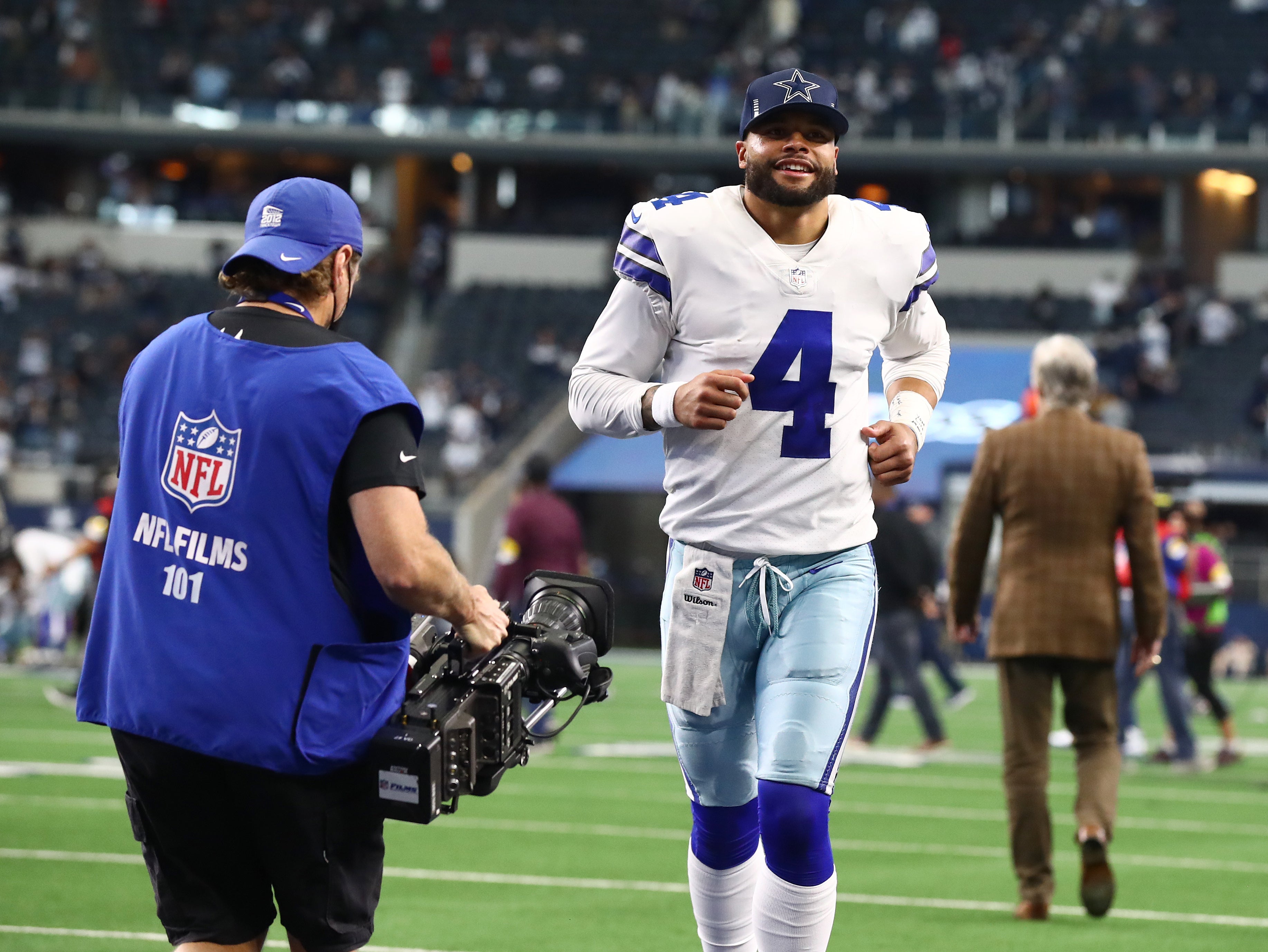 Dallas Cowboys quarterback Dak Prescott (4) smiles as he leaves the field after a victory against the Atlanta Falcons at AT&T Stadium.