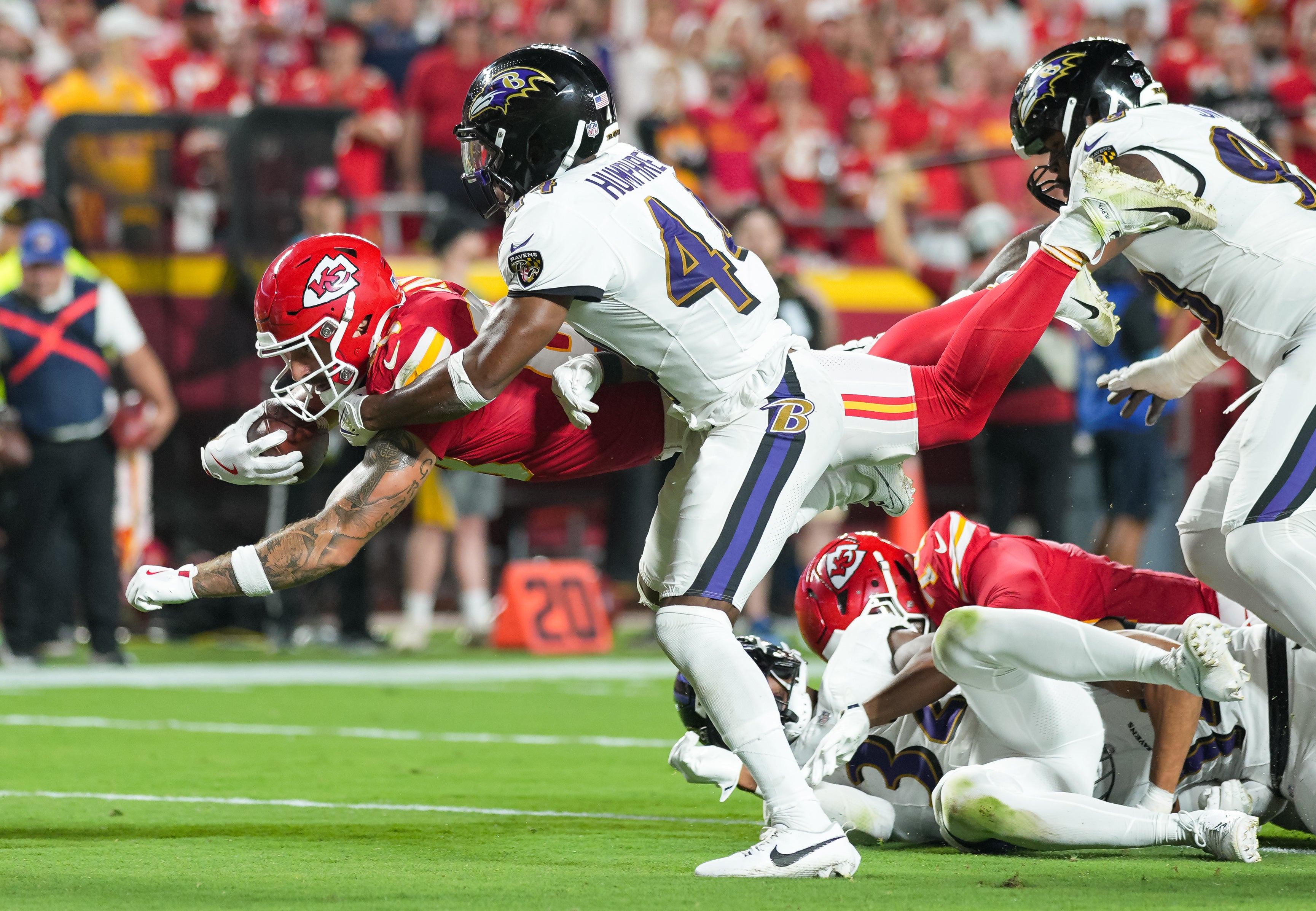 Sep 5, 2024; Kansas City, Missouri, USA; Kansas City Chiefs tight end Noah Gray (83) dives forward against Baltimore Ravens cornerback Marlon Humphrey (44) during the second half at GEHA Field at Arrowhead Stadium.