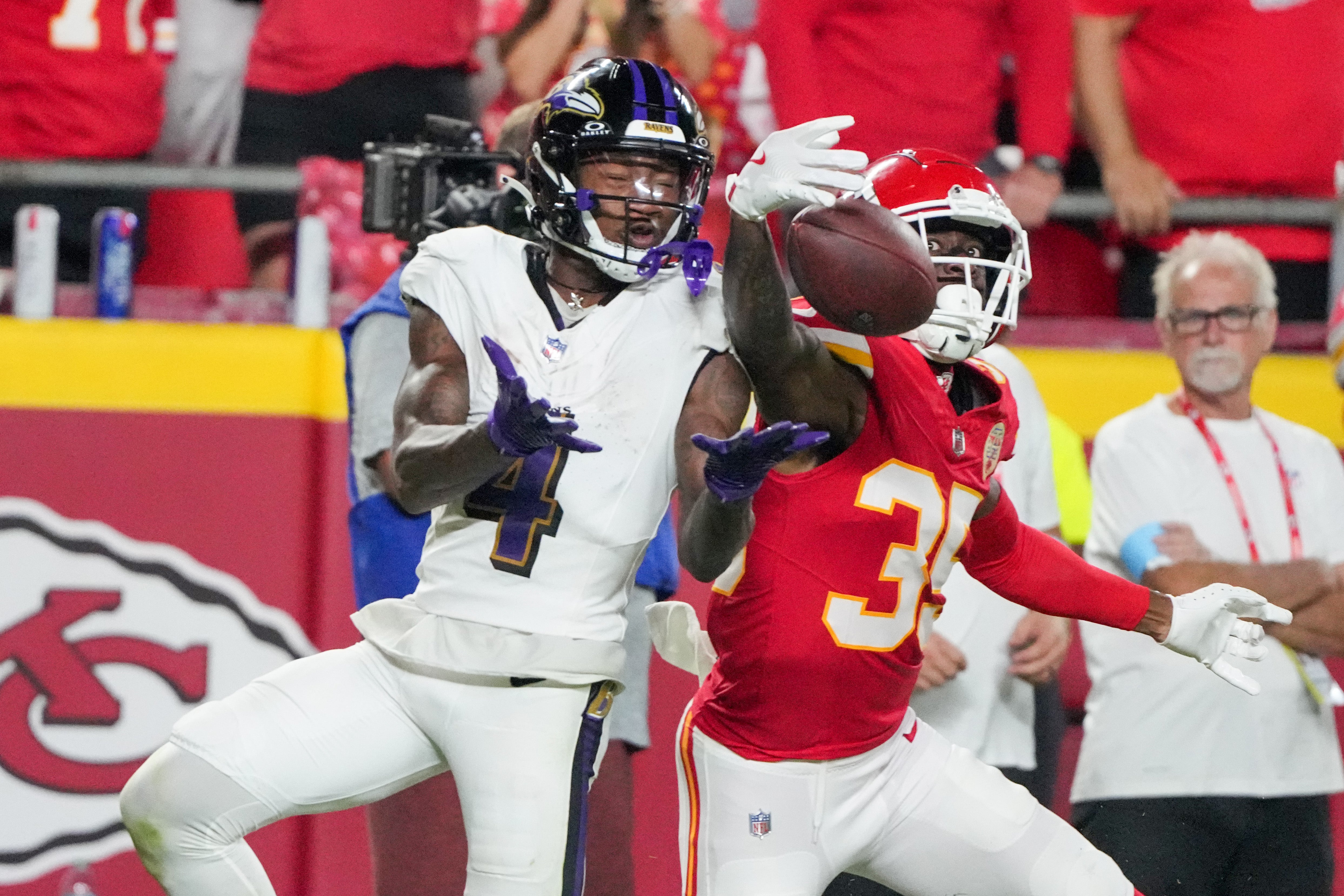 Sep 5, 2024; Kansas City, Missouri, USA; Kansas City Chiefs cornerback Jaylen Watson (35) breaks up a pass intended for Baltimore Ravens wide receiver Zay Flowers (4) during the second half at GEHA Field at Arrowhead Stadium.