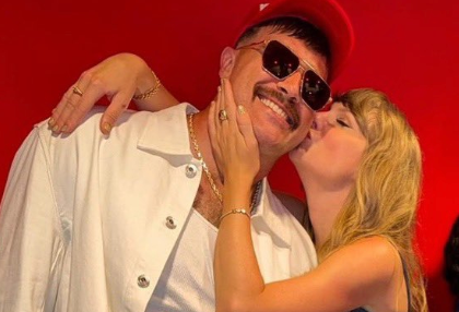 Taylor Swift kisses Travis Kelce's cheek after the first game of the 2023 NFL season.