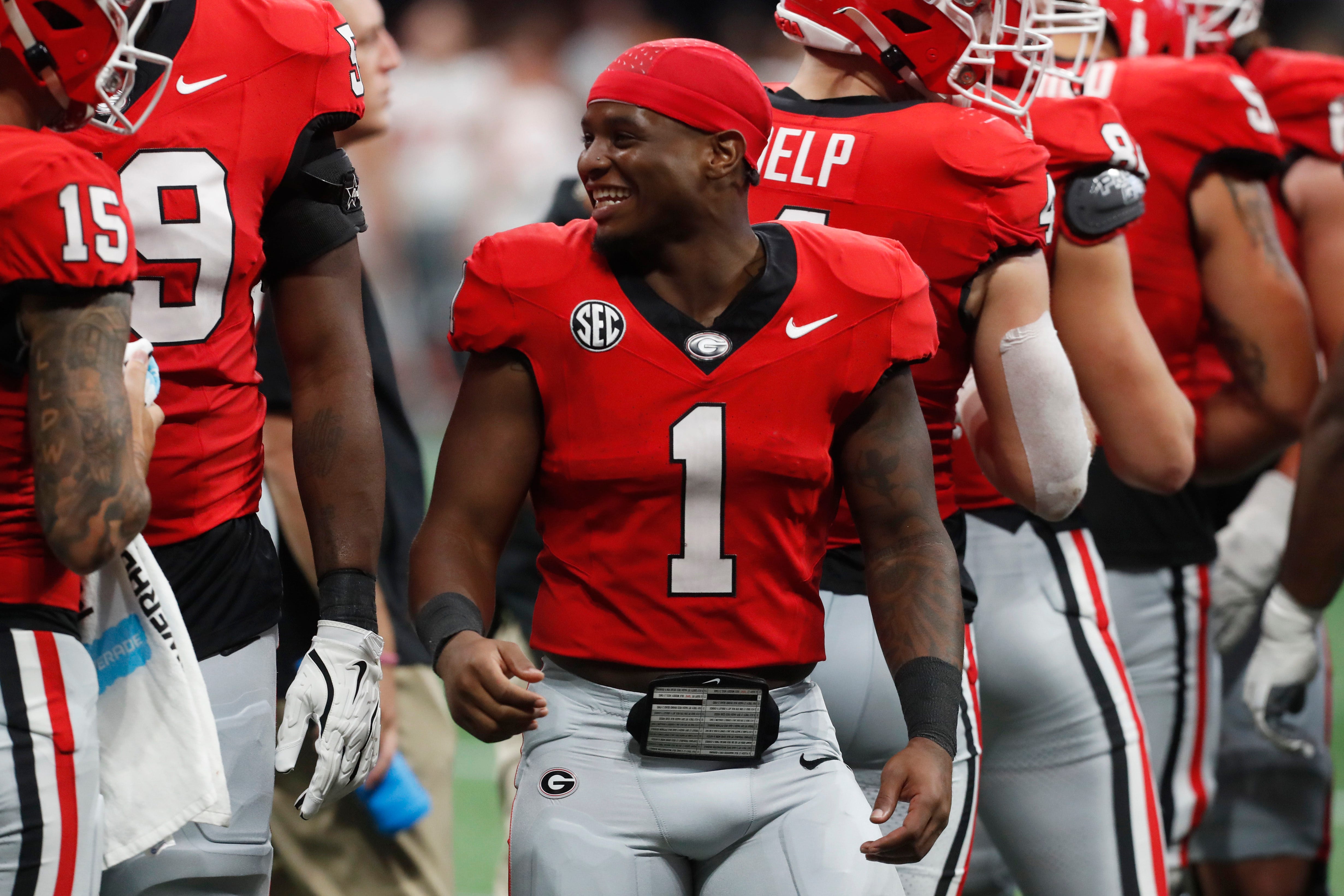 Georgia running back Trevor Etienne (1) in the huddle without a helmet during the first half of the NCAA Aflac Kickoff Game against Clemson in Atlanta, on Saturday, Aug. 31, 2024.
