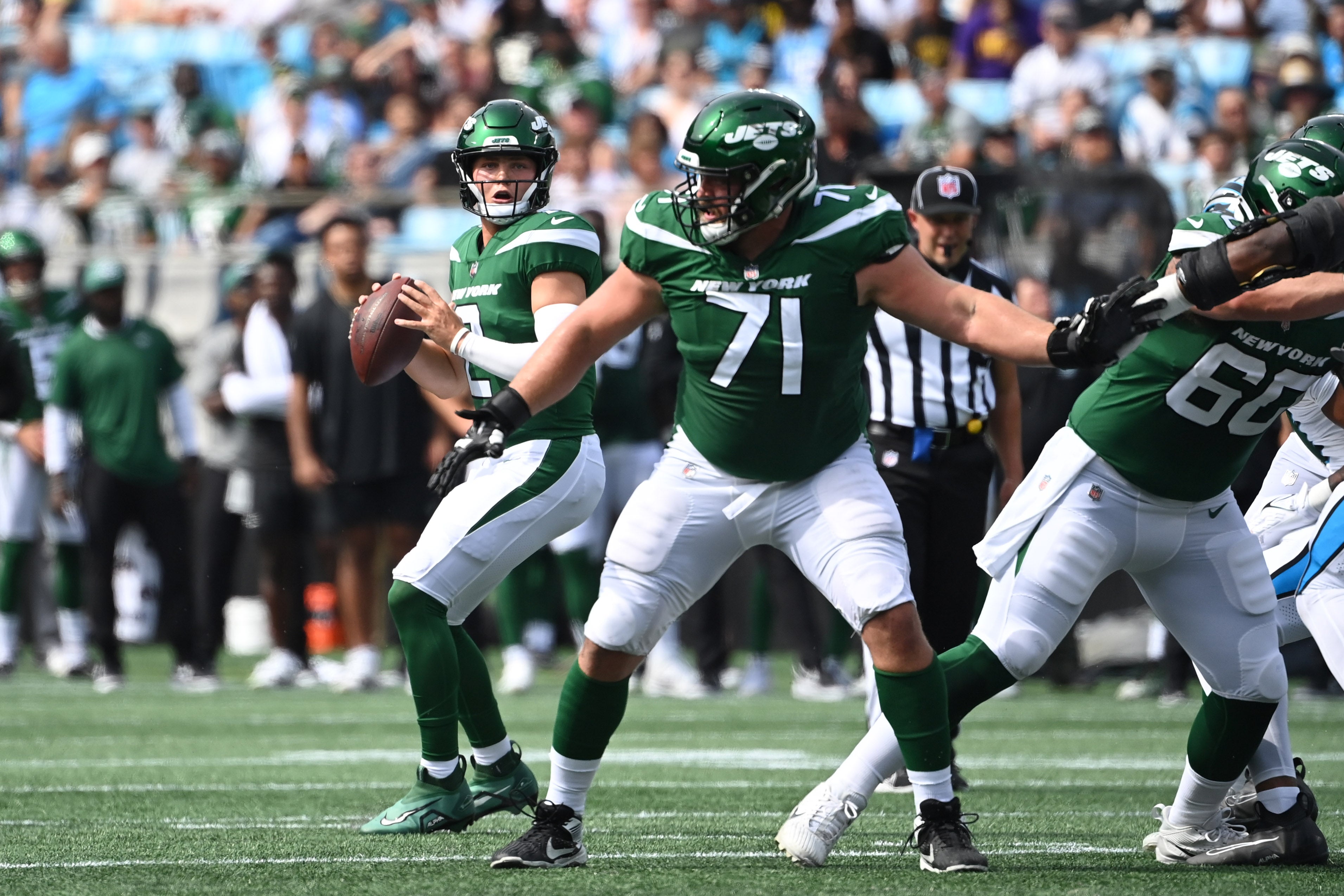 New York Jets quarterback Zach Wilson (2) looks to pass as guard Wes Schweitzer (71) blocks in the first quarter at Bank of America Stadium.