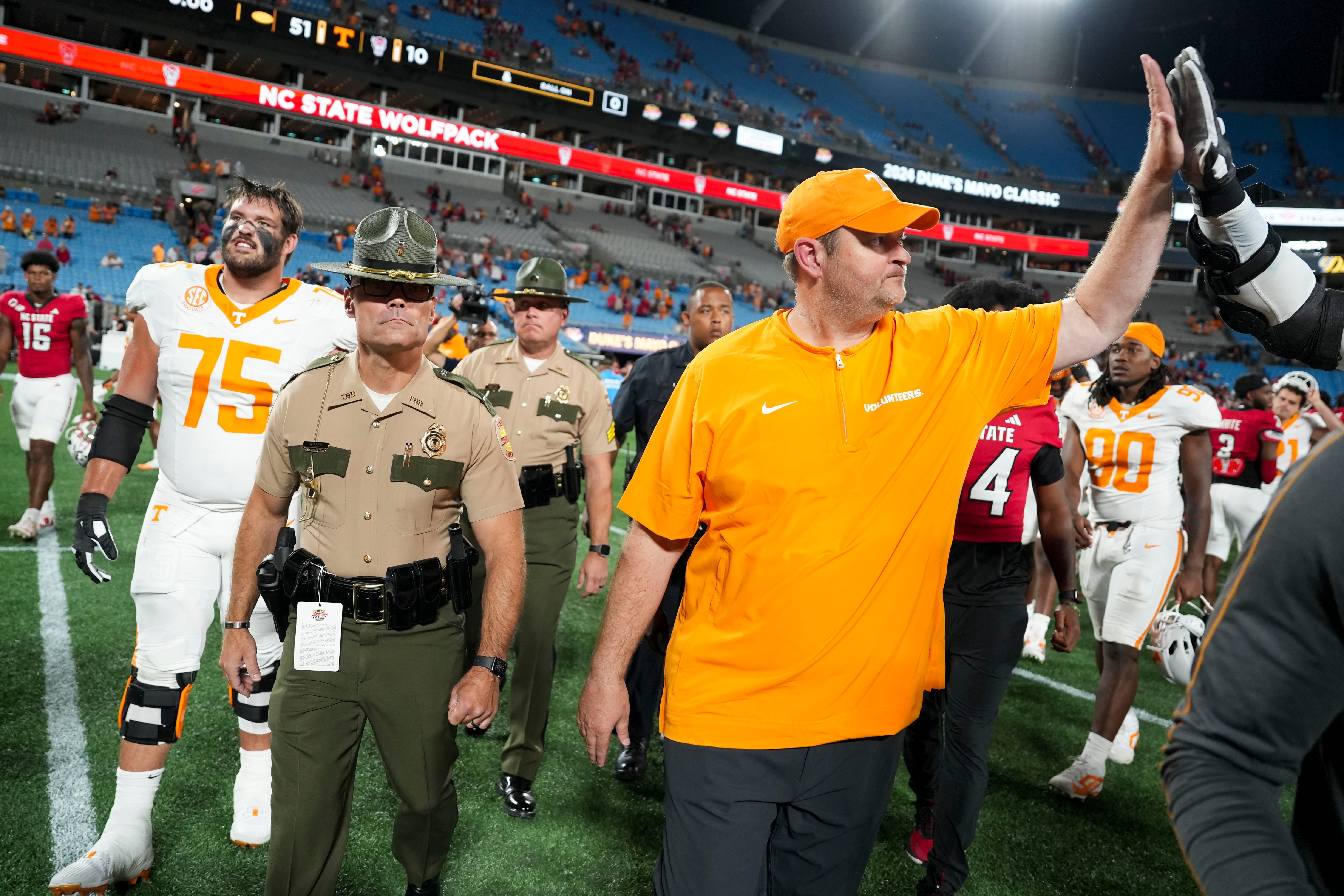 Tennessee head coach Josh Heupel slaps hands with Tennessee offensive lineman Lance Heard (53) after the win over NC State in the Duke's Mayo Classic NCAA College football game on Saturday, Sept. 7, 2024 in Charlotte, NC.