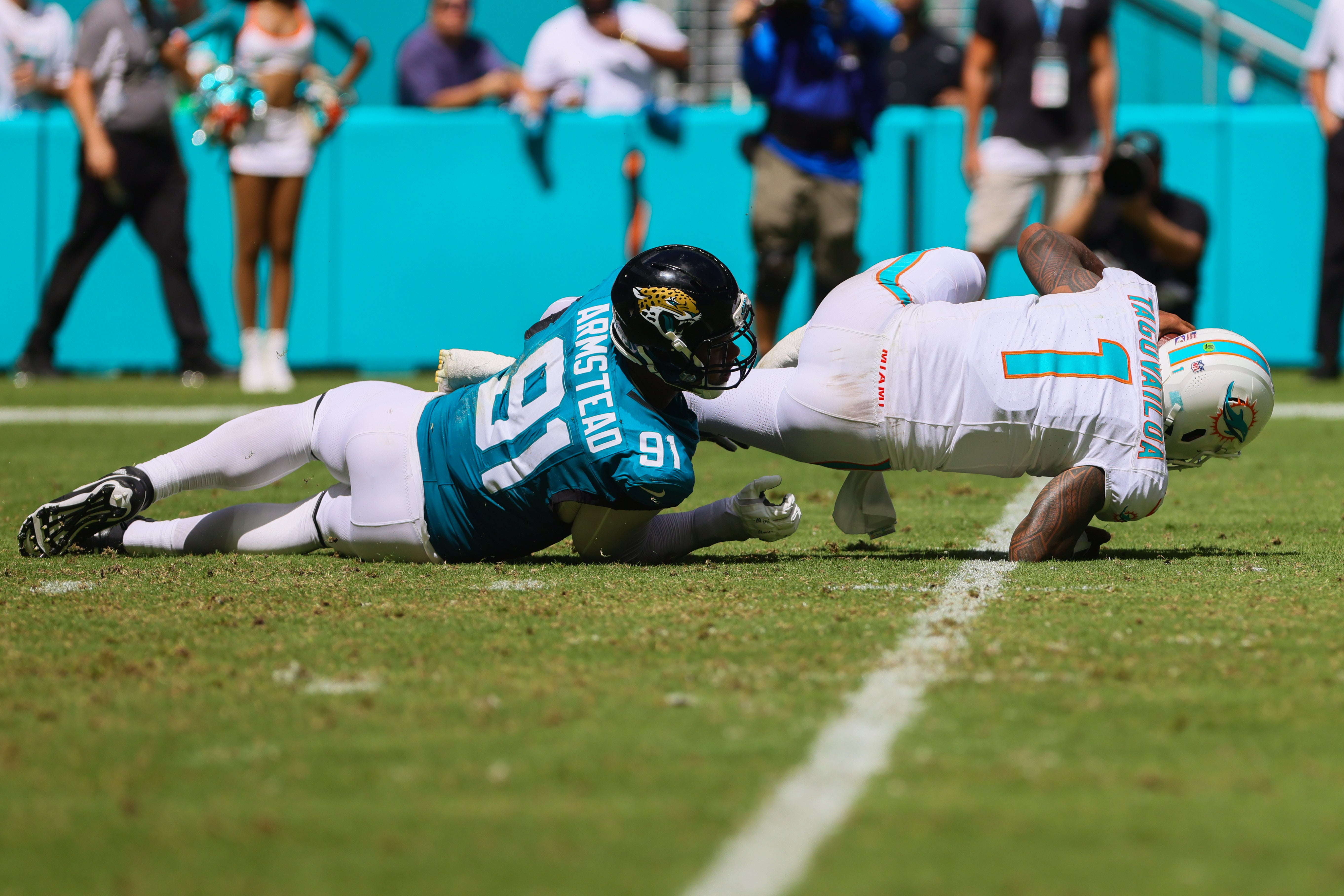 Sep 8, 2024; Miami Gardens, Florida, USA; Miami Dolphins quarterback Tua Tagovailoa (1) is sacked by Jacksonville Jaguars defensive end Arik Armstead (91) during the third quarter at Hard Rock Stadium.