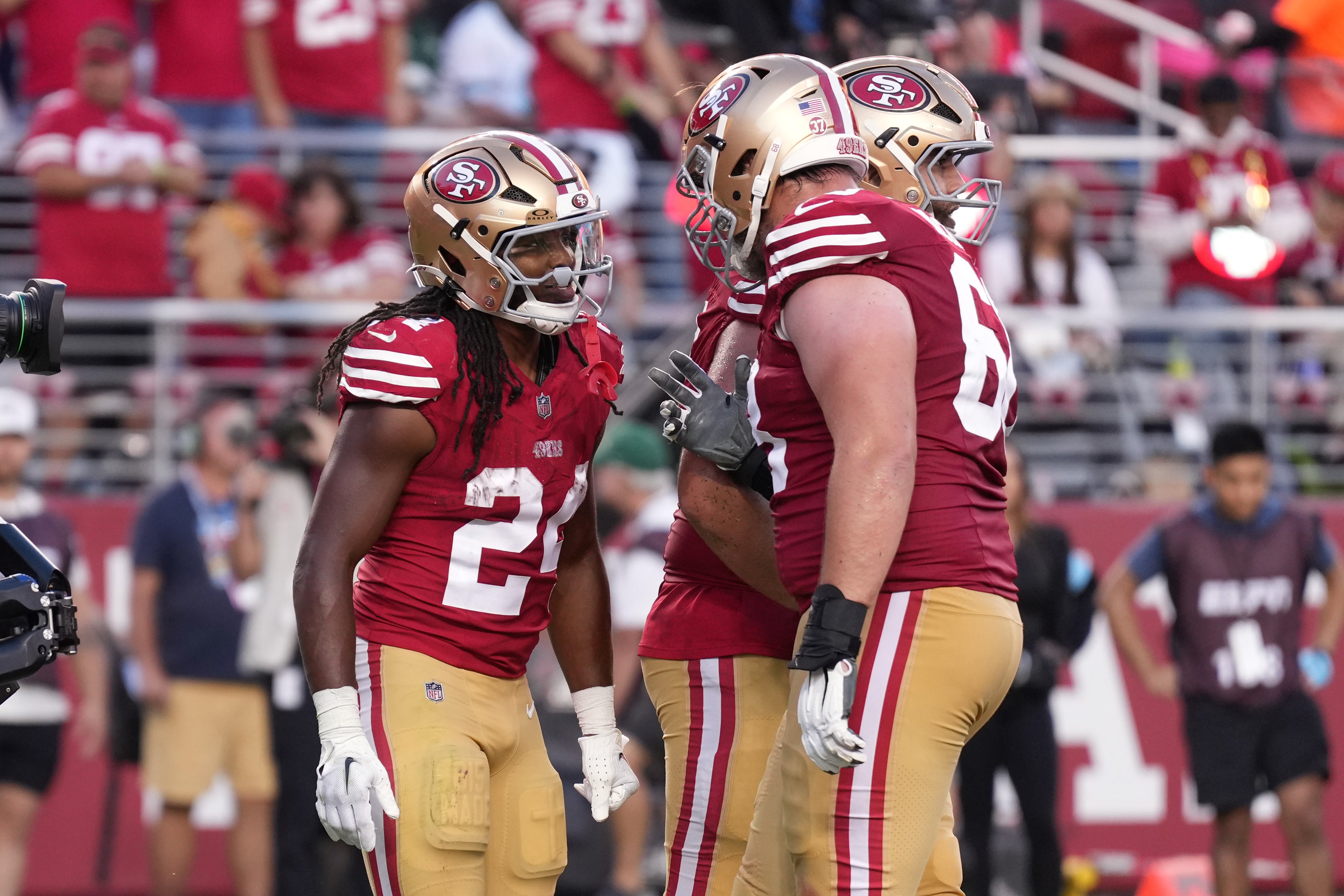 Sep 9, 2024; Santa Clara, California, USA; San Francisco 49ers running back Jordan Mason (left) celebrates with offensive tackle Colton McKivitz (right) after scoring a touchdown against the New York Jets during the third quarter at Levi's Stadium.