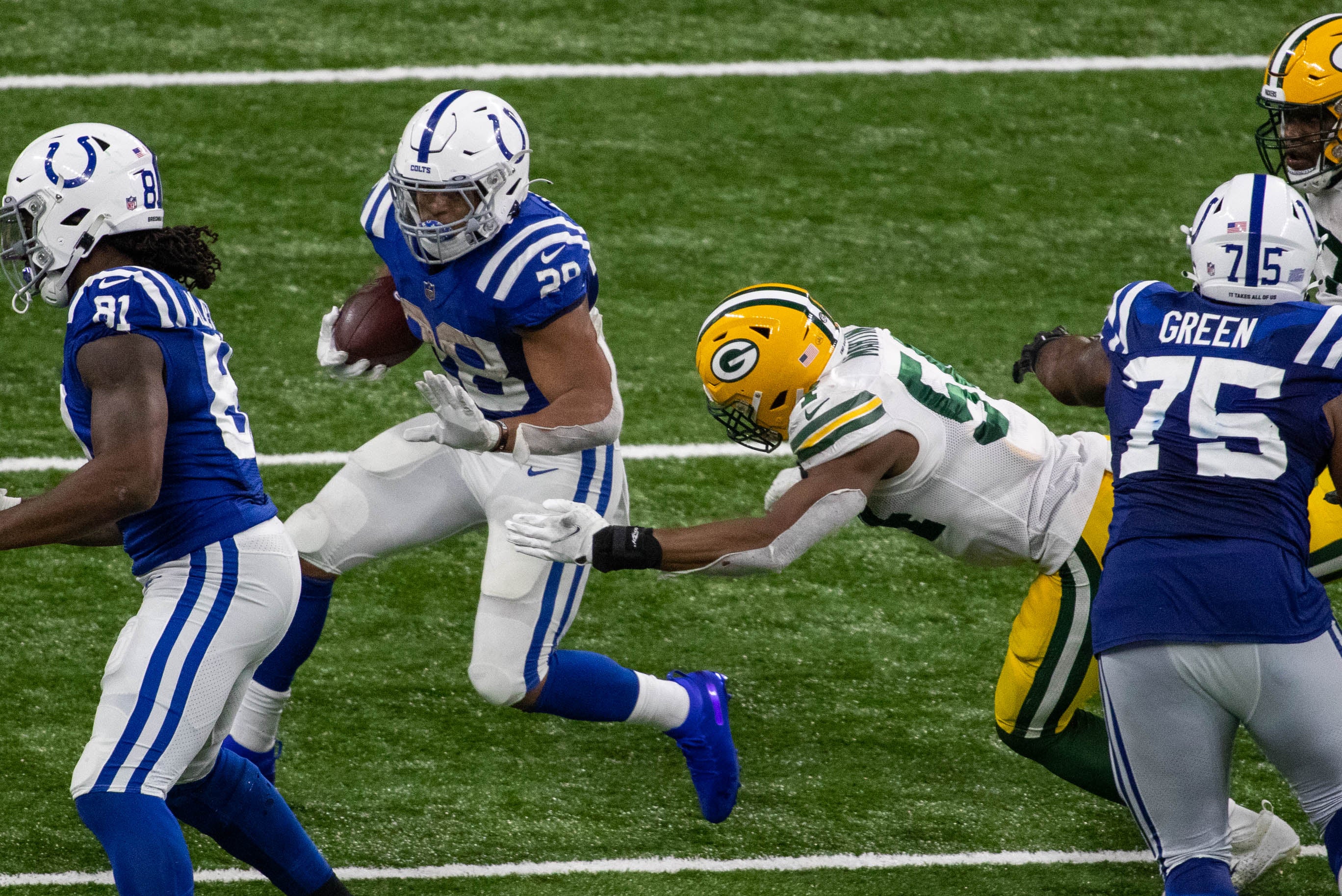 Nov 22, 2020; Indianapolis, Indiana, USA; Indianapolis Colts running back Jordan Wilkins (20) runs the ball in the second half against the Green Bay Packers at Lucas Oil Stadium.