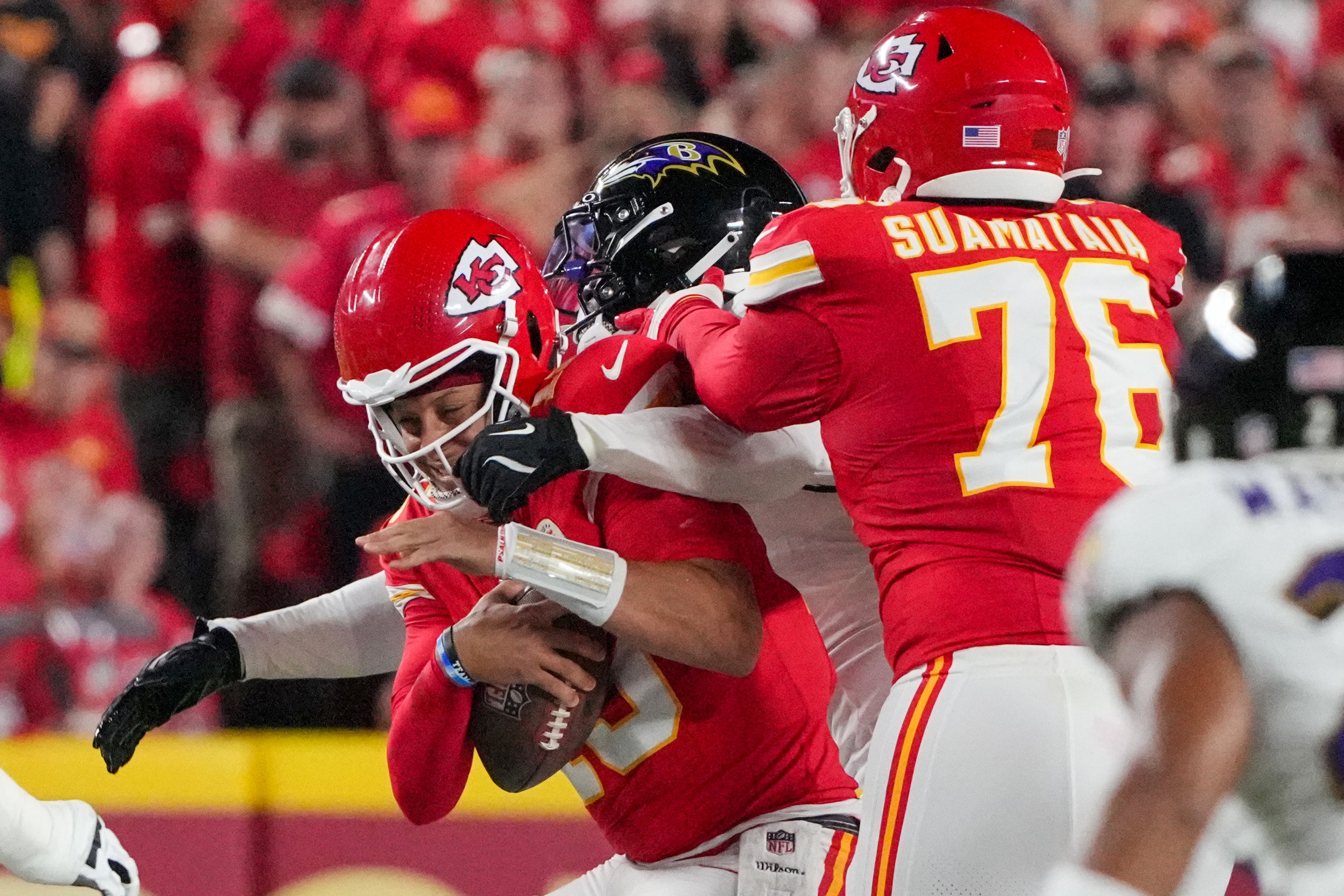 Sep 5, 2024; Kansas City, Missouri, USA; Kansas City Chiefs quarterback Patrick Mahomes (15) is sacked by Baltimore Ravens linebacker David Ojabo (90) during the first half at GEHA Field at Arrowhead Stadium.