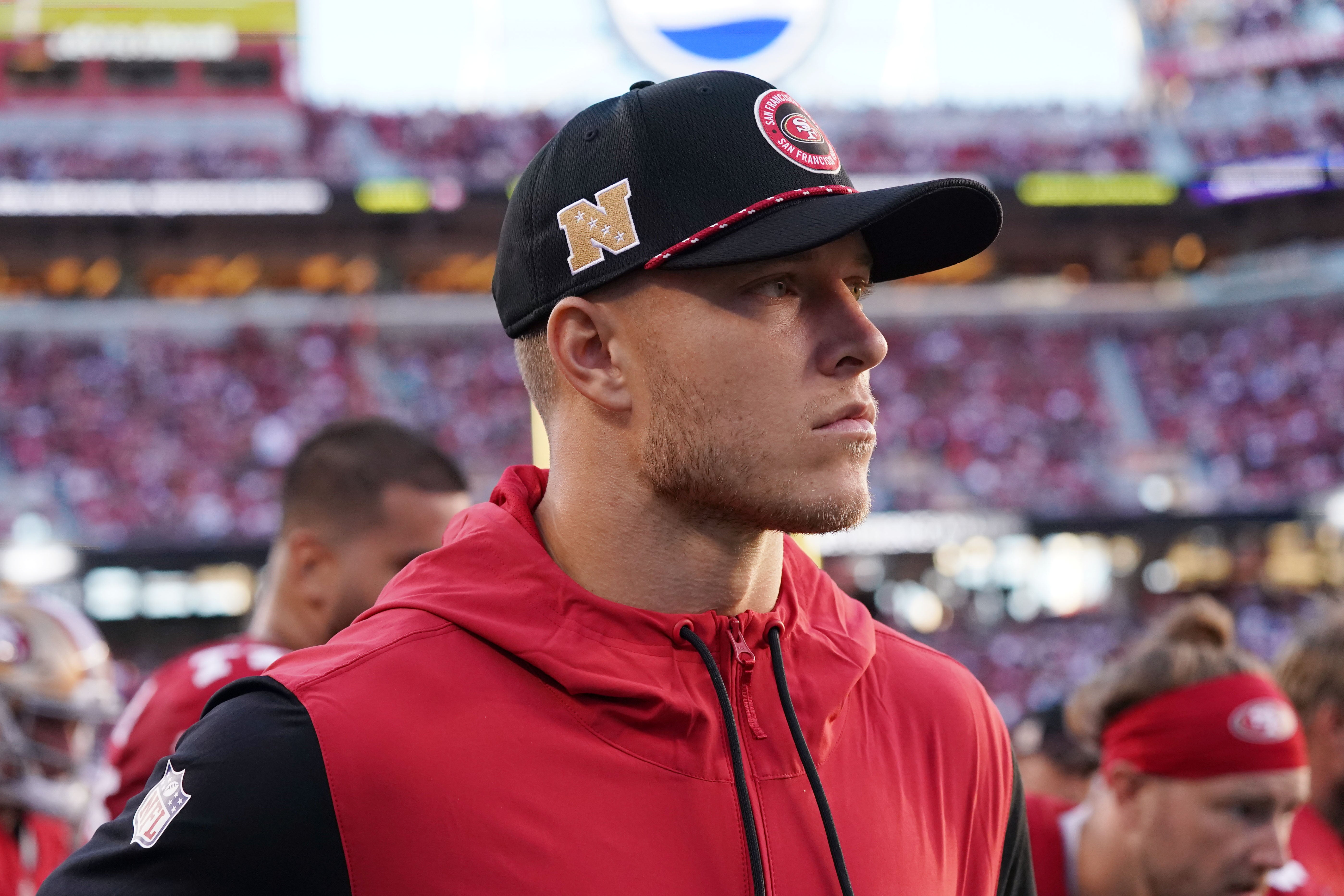 Sep 9, 2024; Santa Clara, California, USA; San Francisco 49ers running back Christian McCaffrey (23) watches from the sideline due to injury during the second quarter against the New York Jets at Levi's Stadium.