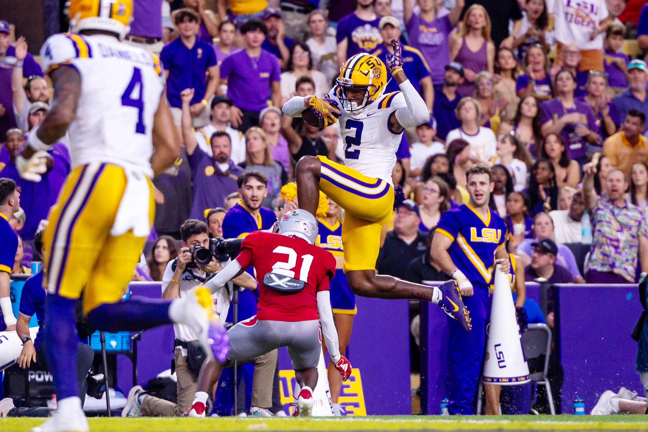 LSU wide receiver Kyren Lacy leaps over a Nicholls State defensive back