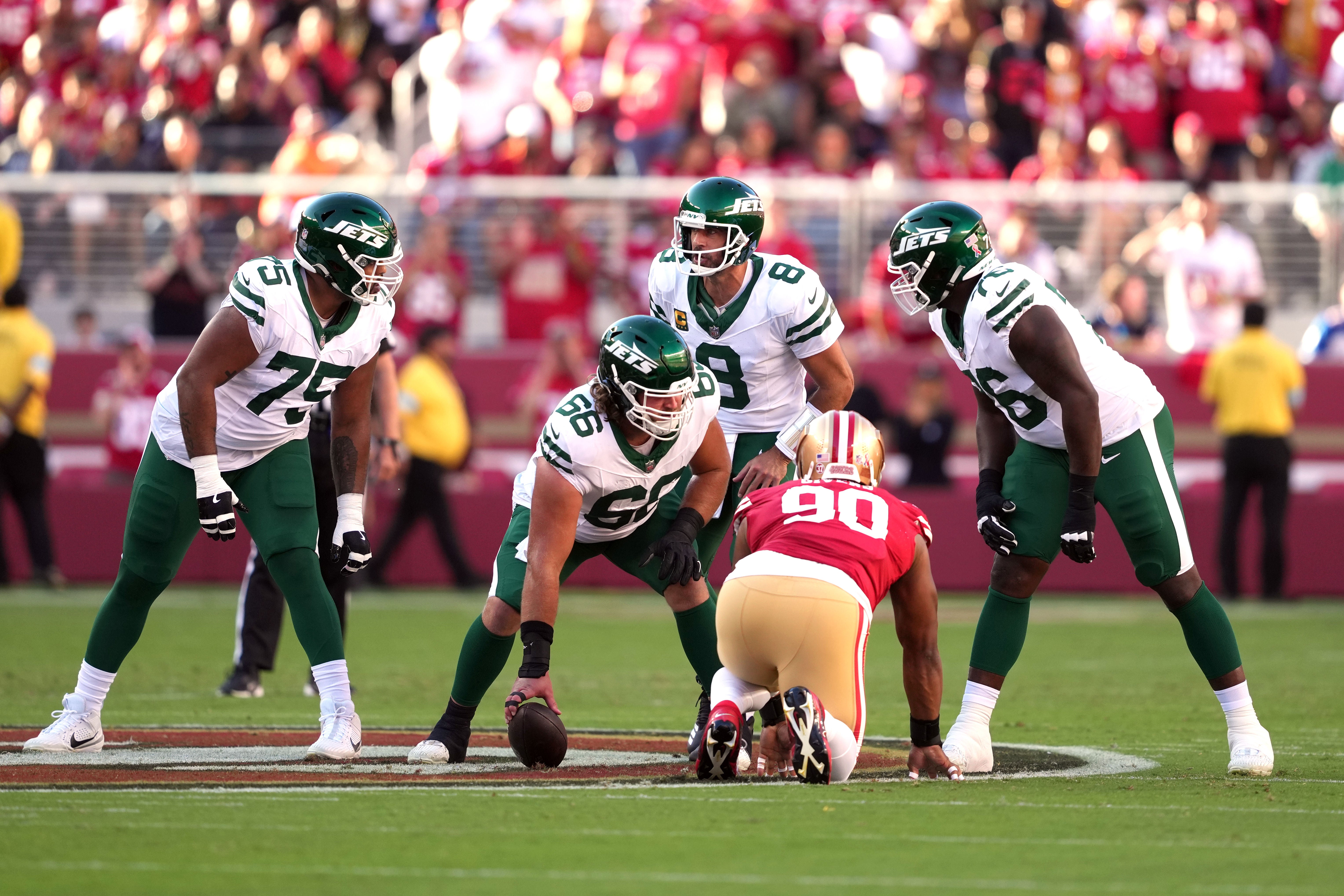 Sep 9, 2024; Santa Clara, California, USA; New York Jets quarterback Aaron Rodgers (8) talks with guards Alijah Vera-Tucker (75) and John Simpson (76) and center Joe Tippmann (66) before a snap against the San Francisco 49ers during the first quarter at Levi's Stadium.