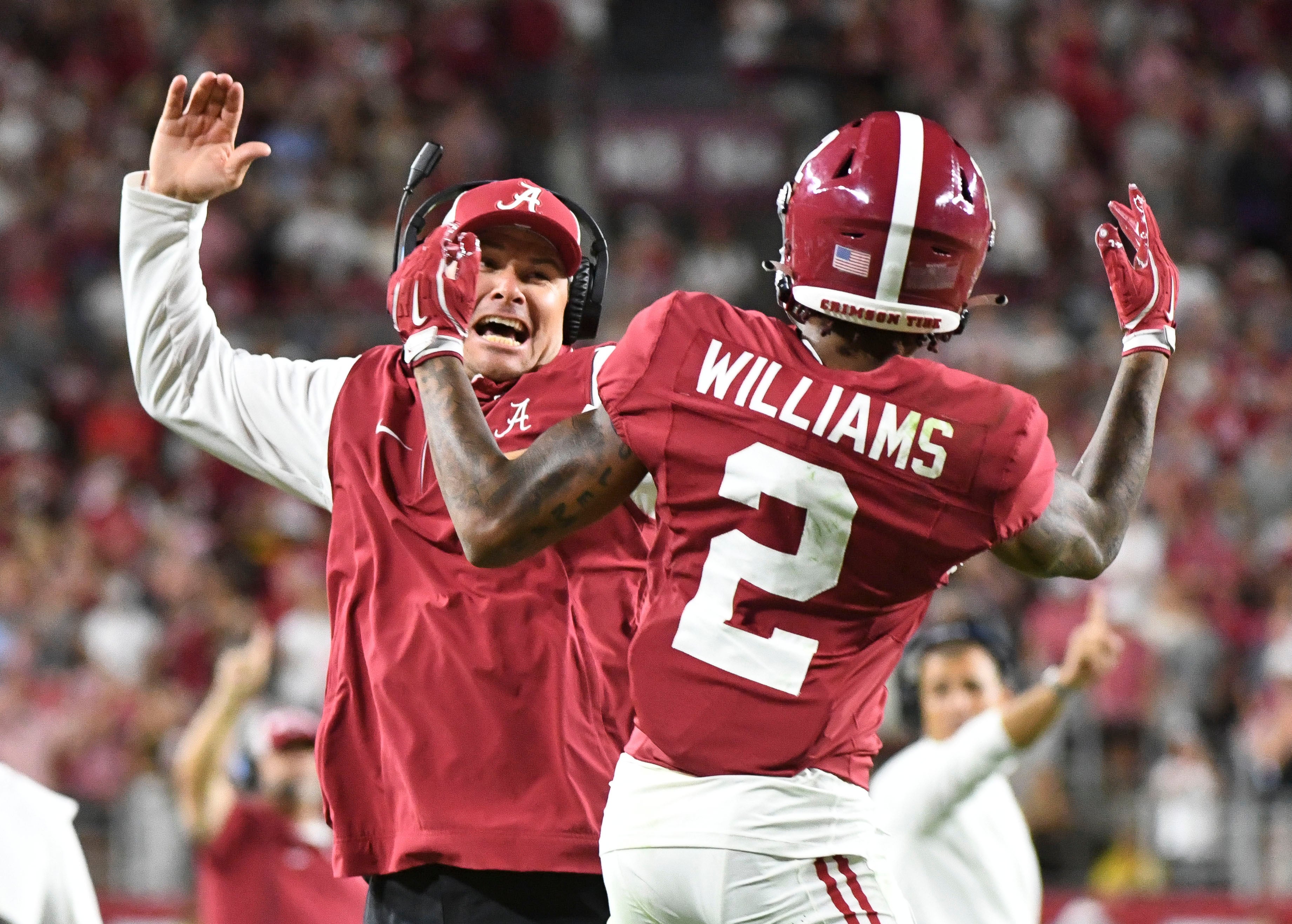 Alabama receiver Ryan Williams (2) celebrates with an assistant coach after scoring a touchdown.