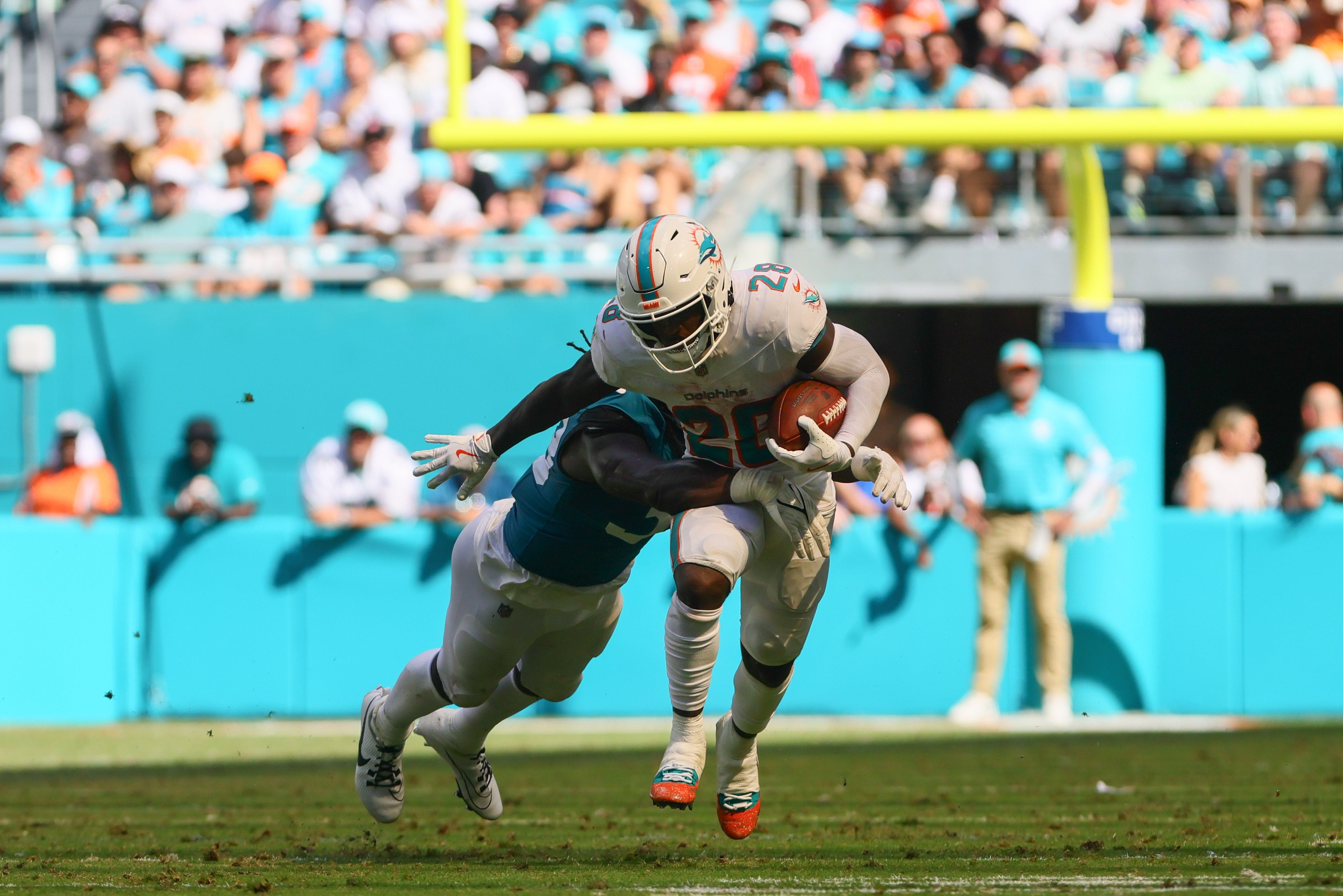 Sep 8, 2024; Miami Gardens, Florida, USA; Miami Dolphins running back De'Von Achane (28) runs with the football against the Jacksonville Jaguars during the fourth quarter at Hard Rock Stadium.