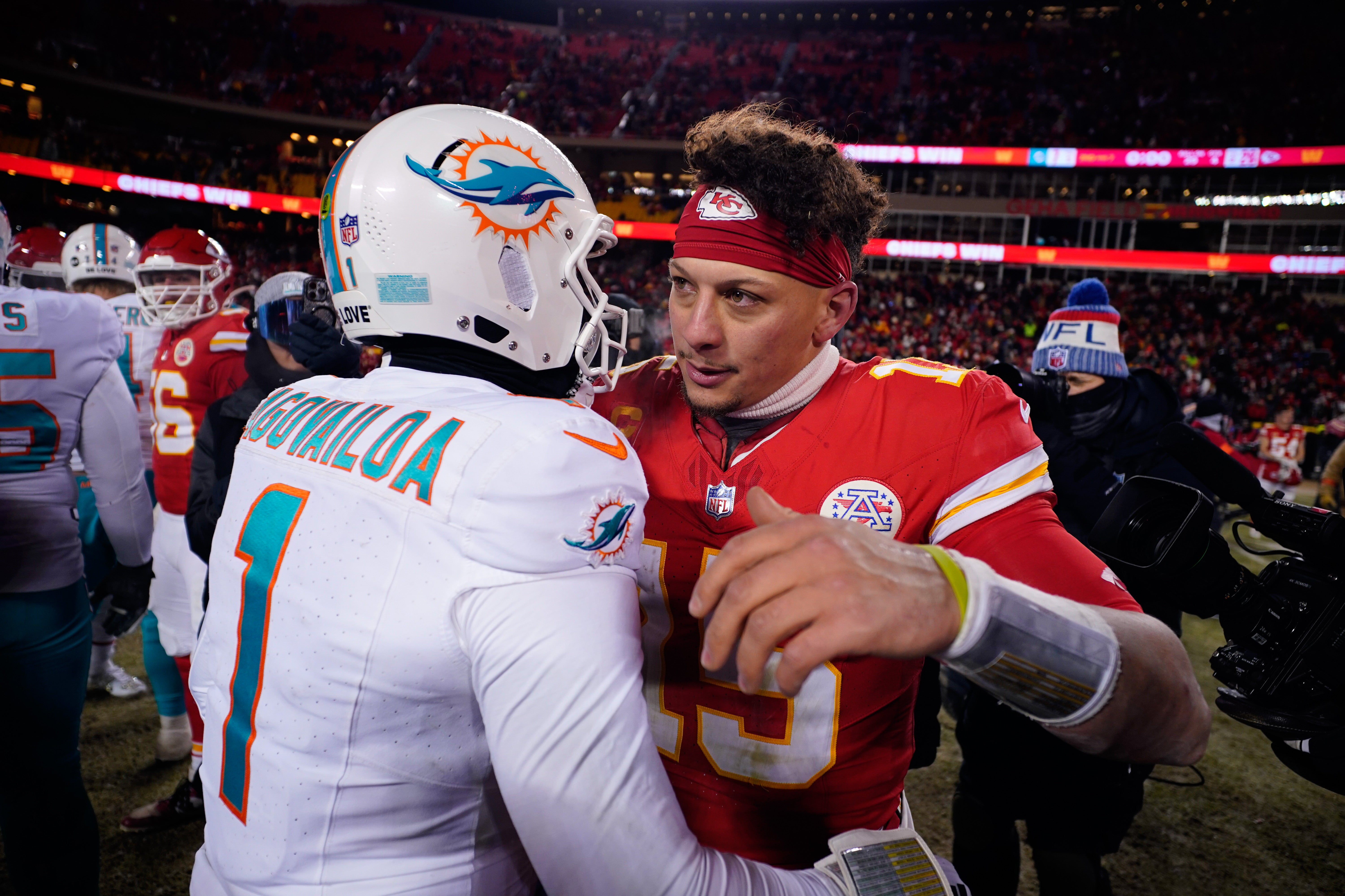 Jan 13, 2024; Kansas City, Missouri, USA; Kansas City Chiefs quarterback Patrick Mahomes (15) meets with Miami Dolphins quarterback Tua Tagovailoa (1) following the 2024 AFC wild card game at GEHA Field at Arrowhead Stadium. 