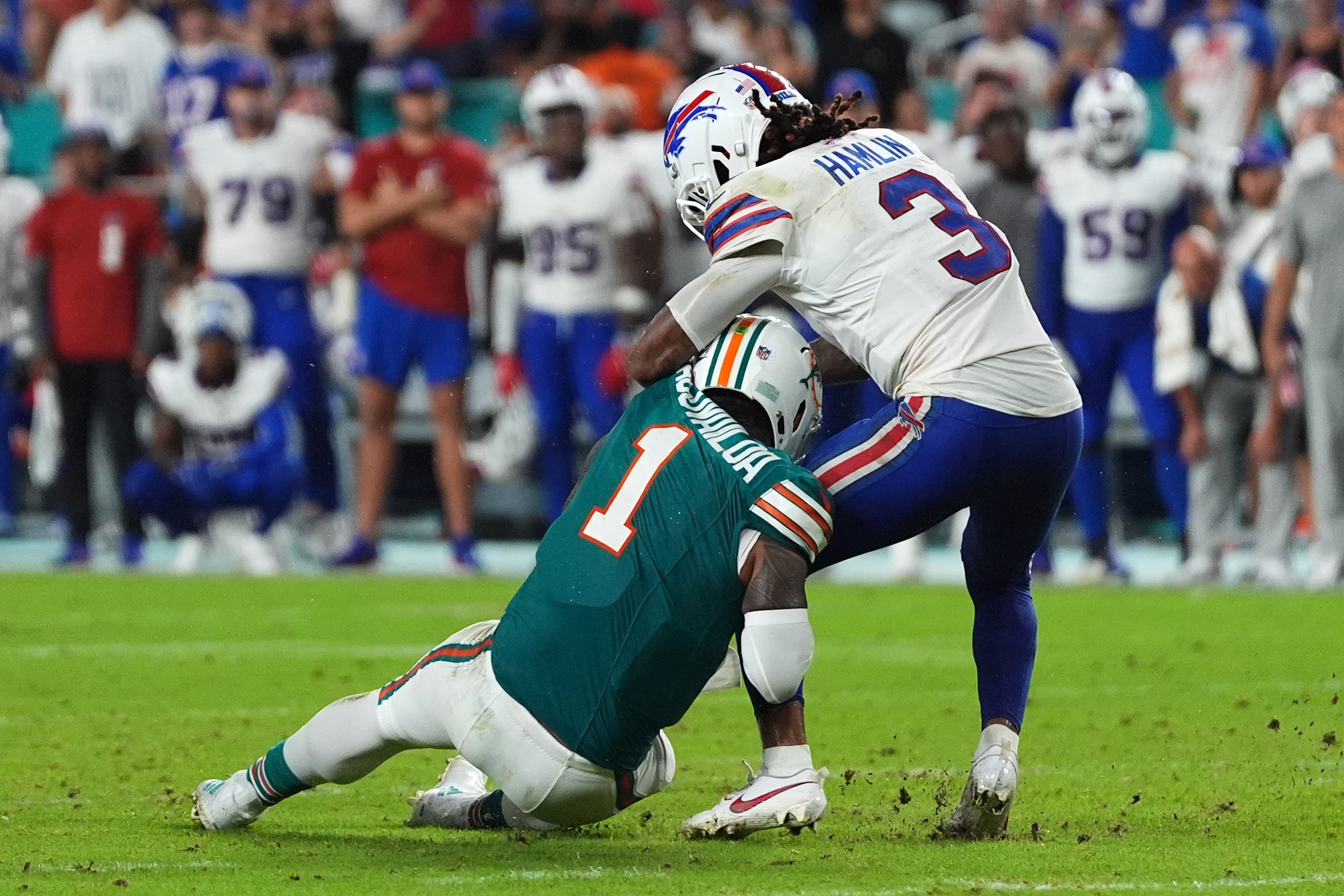 Sep 12, 2024; Miami Gardens, Florida, USA; Buffalo Bills safety Damar Hamlin (3) tackles Miami Dolphins quarterback Tua Tagovailoa (1) during the second half at Hard Rock Stadium.