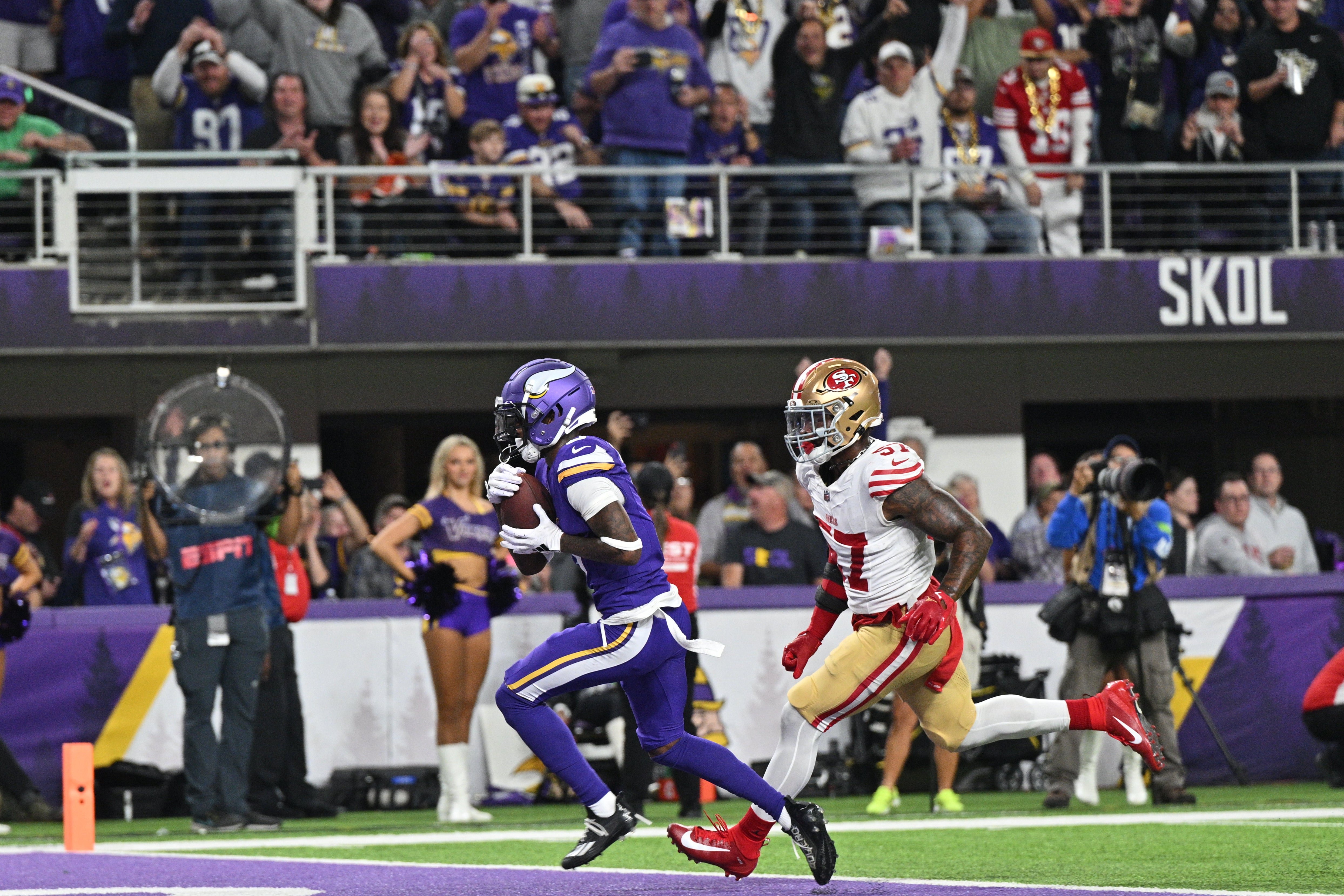 Oct 23, 2023; Minneapolis, Minnesota, USA; Minnesota Vikings wide receiver Jordan Addison (3) catches a touchdown pass from quarterback Kirk Cousins (not pictured) as San Francisco 49ers linebacker Dre Greenlaw (57) chases during the first quarter at U.S. Bank Stadium.